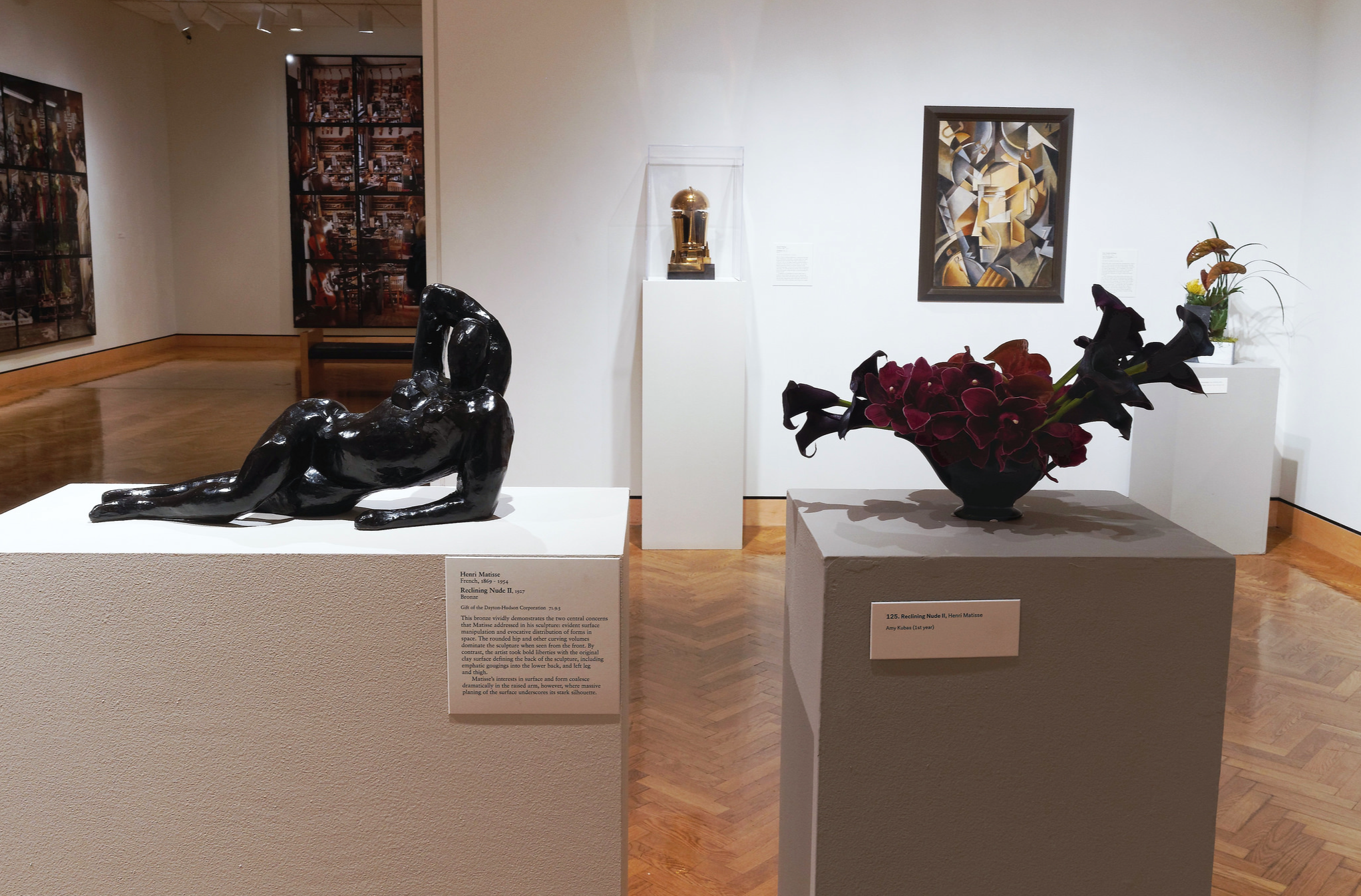dark moody flowers arranged next to Henri Matisse reclining nude sculpture