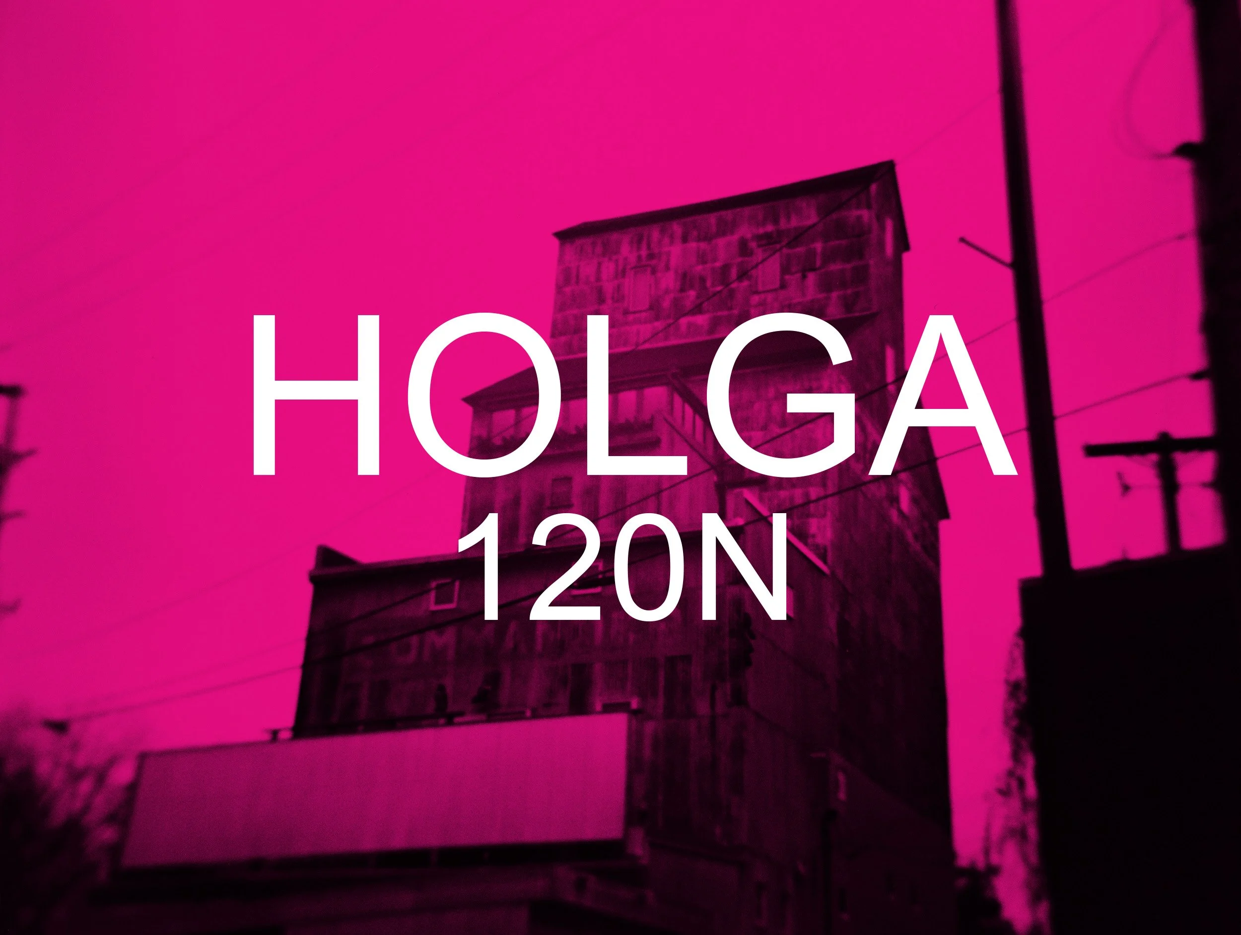 A building under a pink sky with large white text reading 'HOOGA 120N' in front of it.