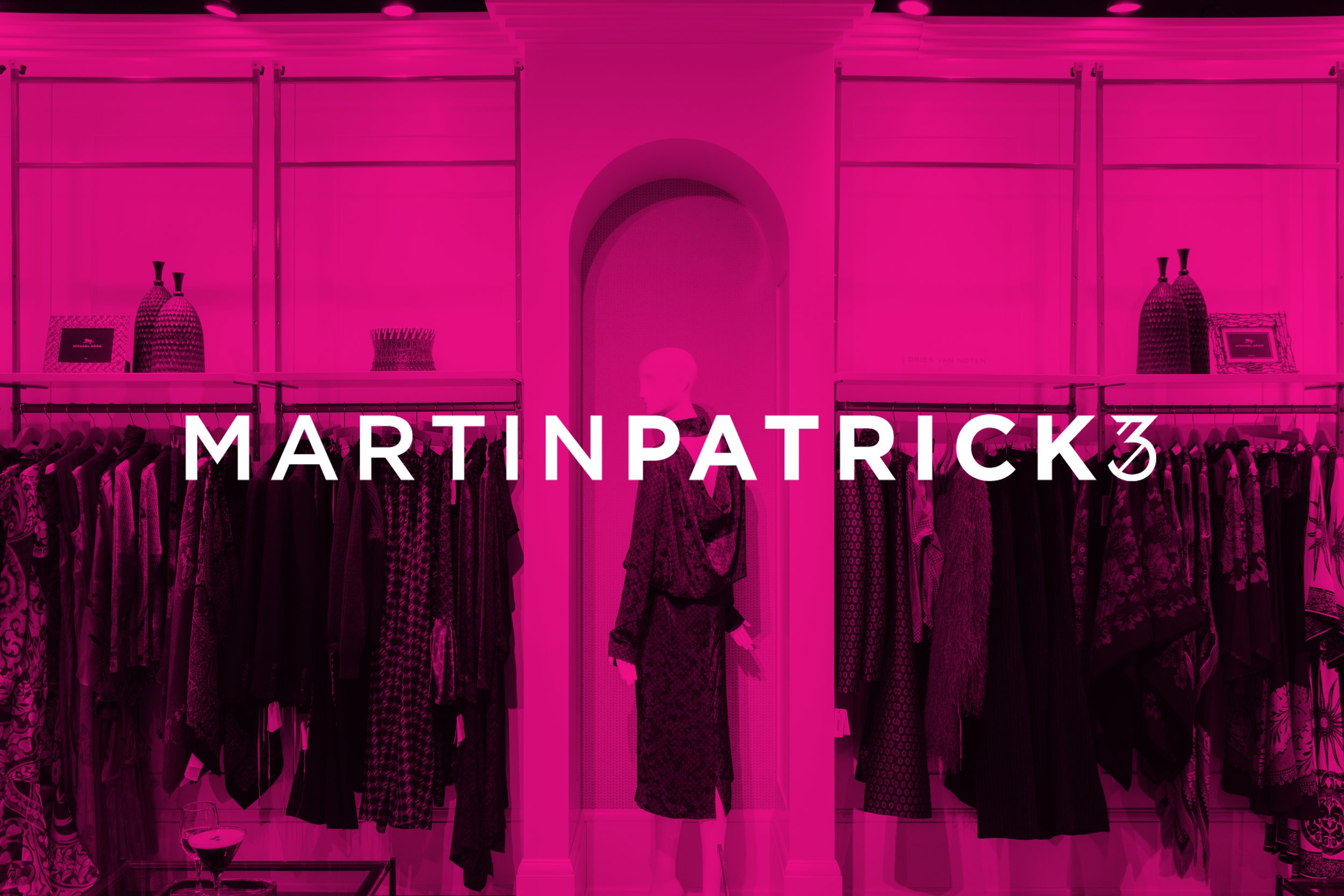 A clothing store with racks of dresses and garments, and a mannequin in the center. The store has pink lighting and the name 'MARTIN PATCH' is prominently displayed.