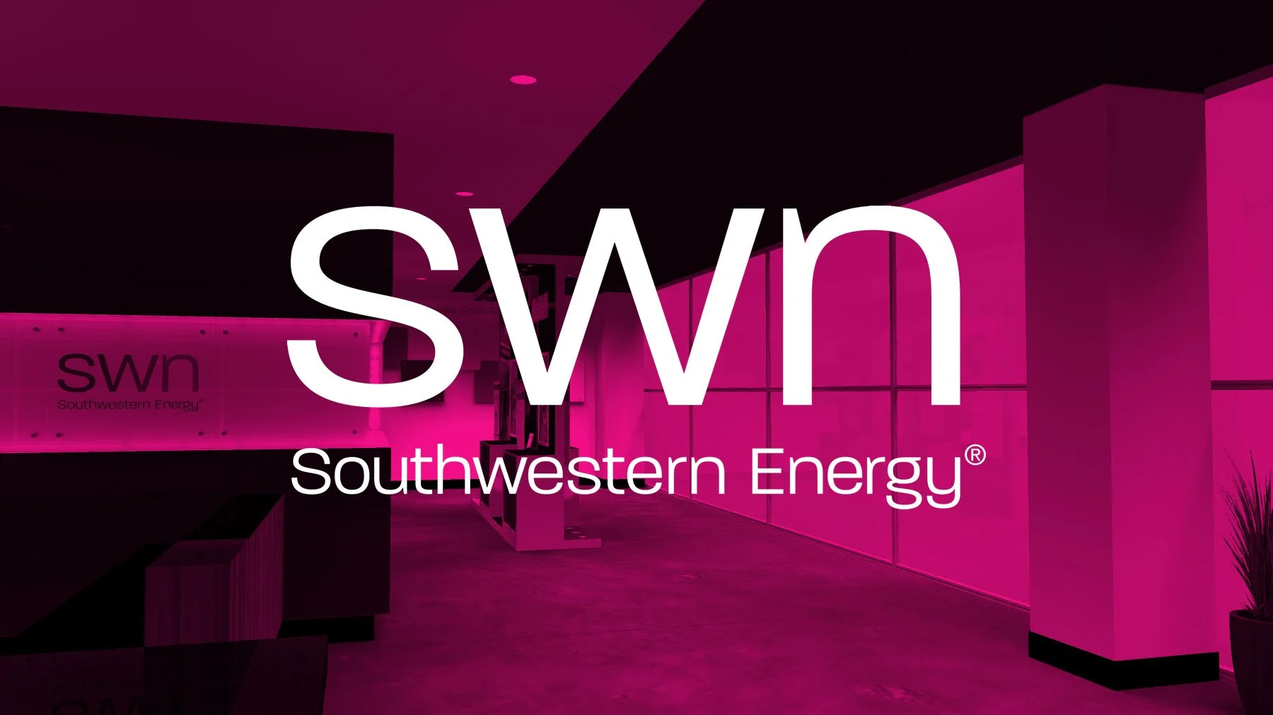 Entrance lobby of Southwestern Energy with a pink translucent title block overlay with the words "SWN SOUTHWESTERN ENERGY" in white letters.
