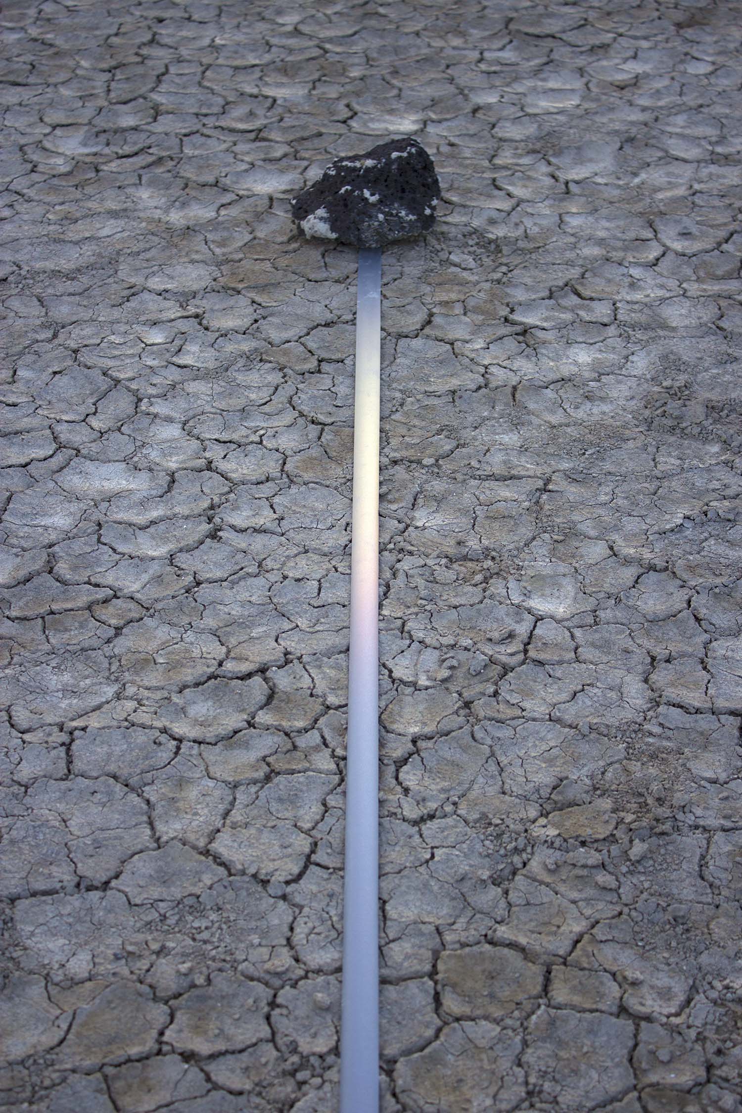    marking time in light  ,&nbsp;2014 (detail) reflective fabric tape, found stones, natural light 8.5 x 1.5 x 1494 in.  Alvord Desert, Eastern Oregon 