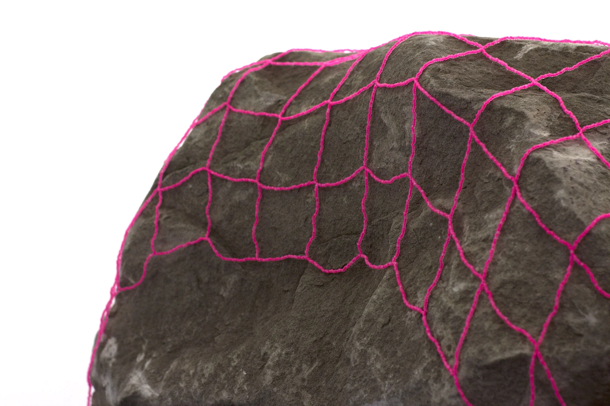 a veil to cover all stones , 2016 (detail) hand-beaded net, sandstone boulder 16.5 x 55.5 x 140 in. as installed TRUCK Contemporary Art , Calgary AB