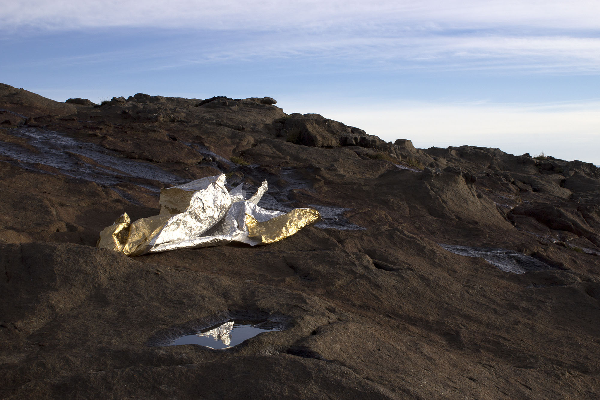    lifting, settling of a mountain  , 2013 foil sheet, natural light, water, wind dimensions variable  Spákonufellshöfði, Skagaströnd, Iceland 