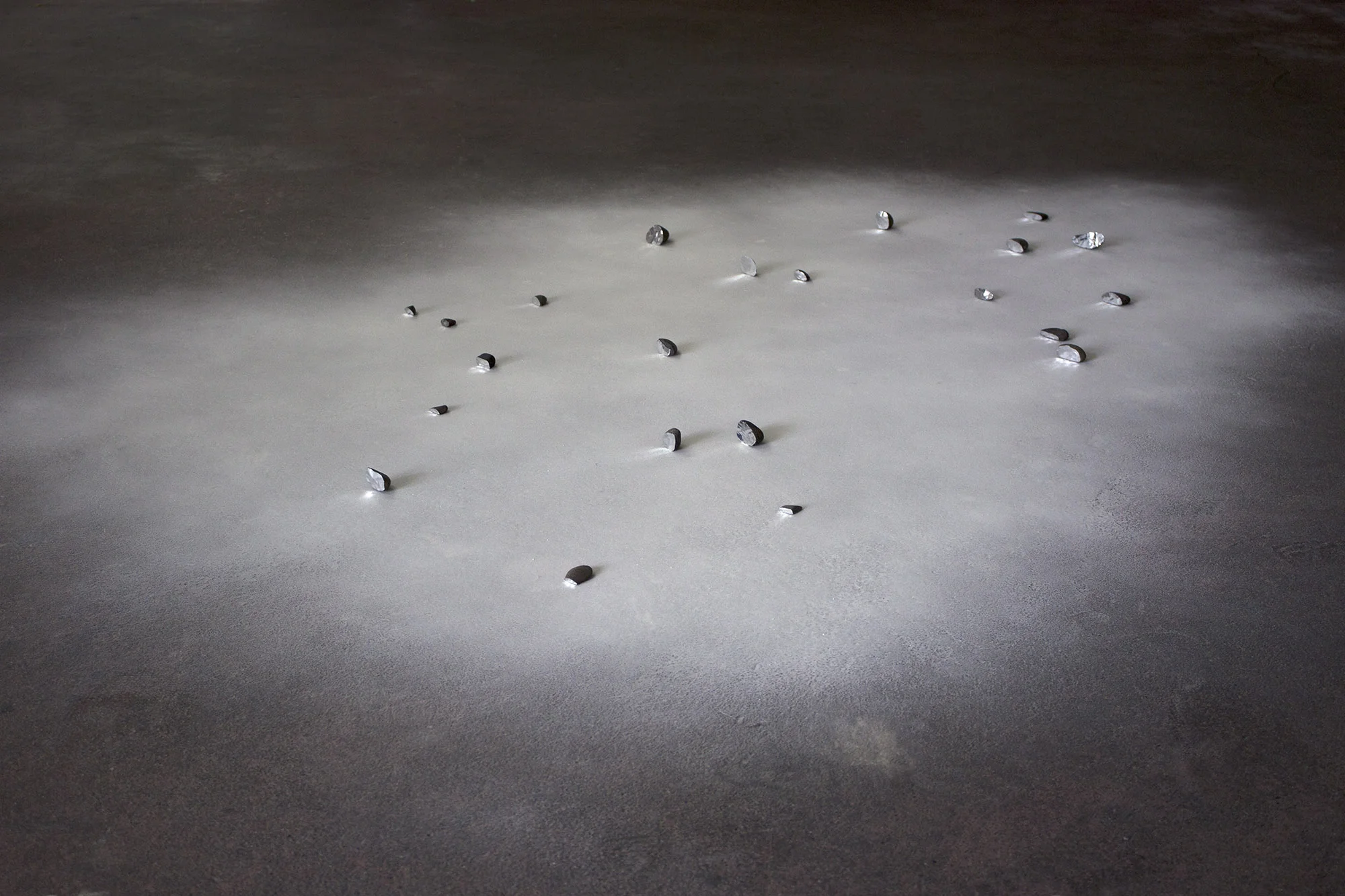 faced , 2013 recovered stones, foil tape, glass microspheres, natural light dimensions variable