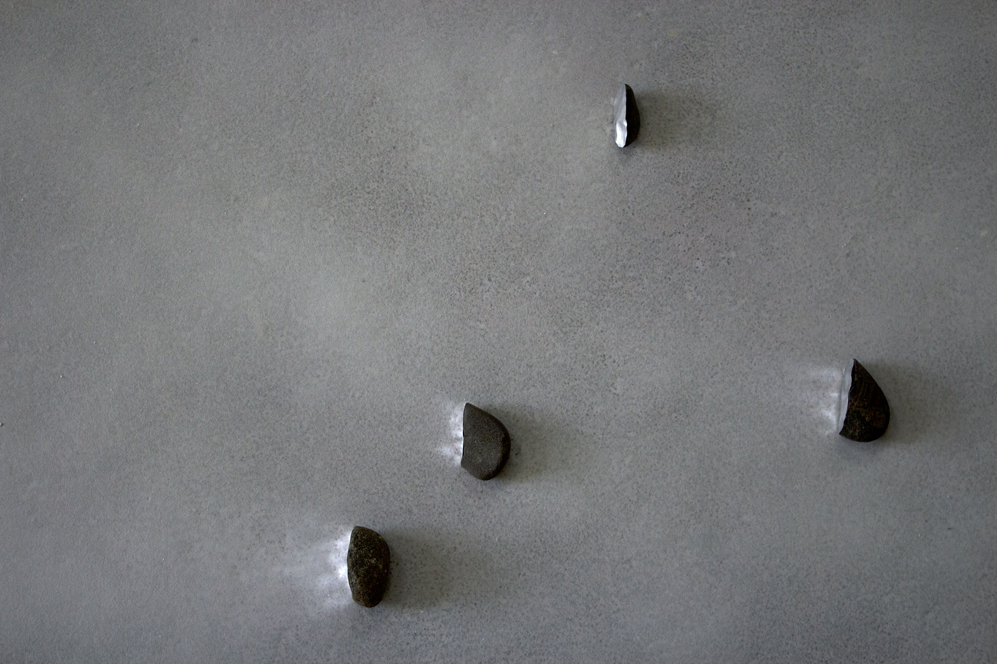    faced  , 2013 (detail) recovered stones, foil tape, glass microspheres, natural light dimensions variable 