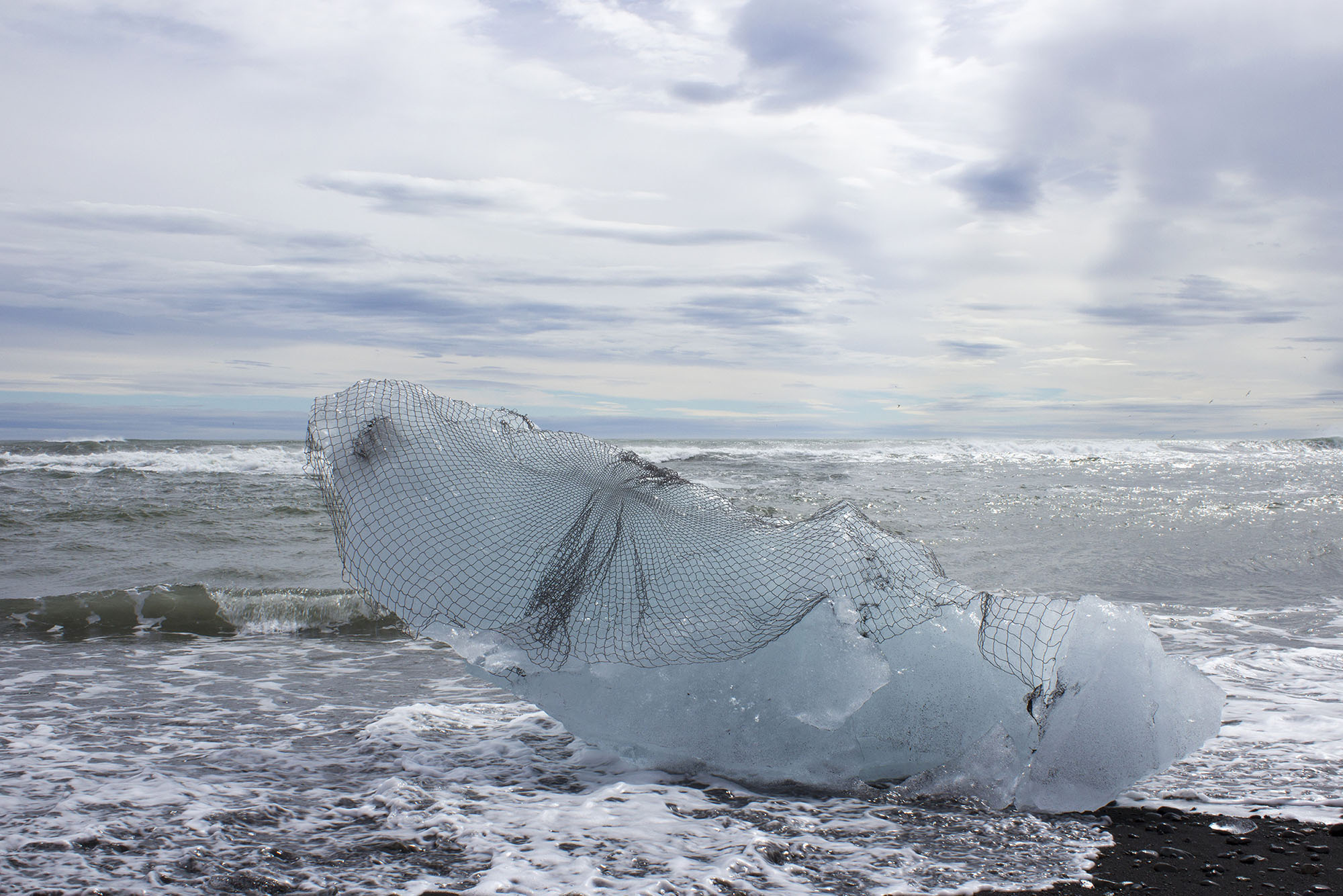 to reinforce a glacier , 2017 hand-beaded net, calved iceberg site-responsive installation Breiðamerkurjökull, Vatnajökull, Iceland