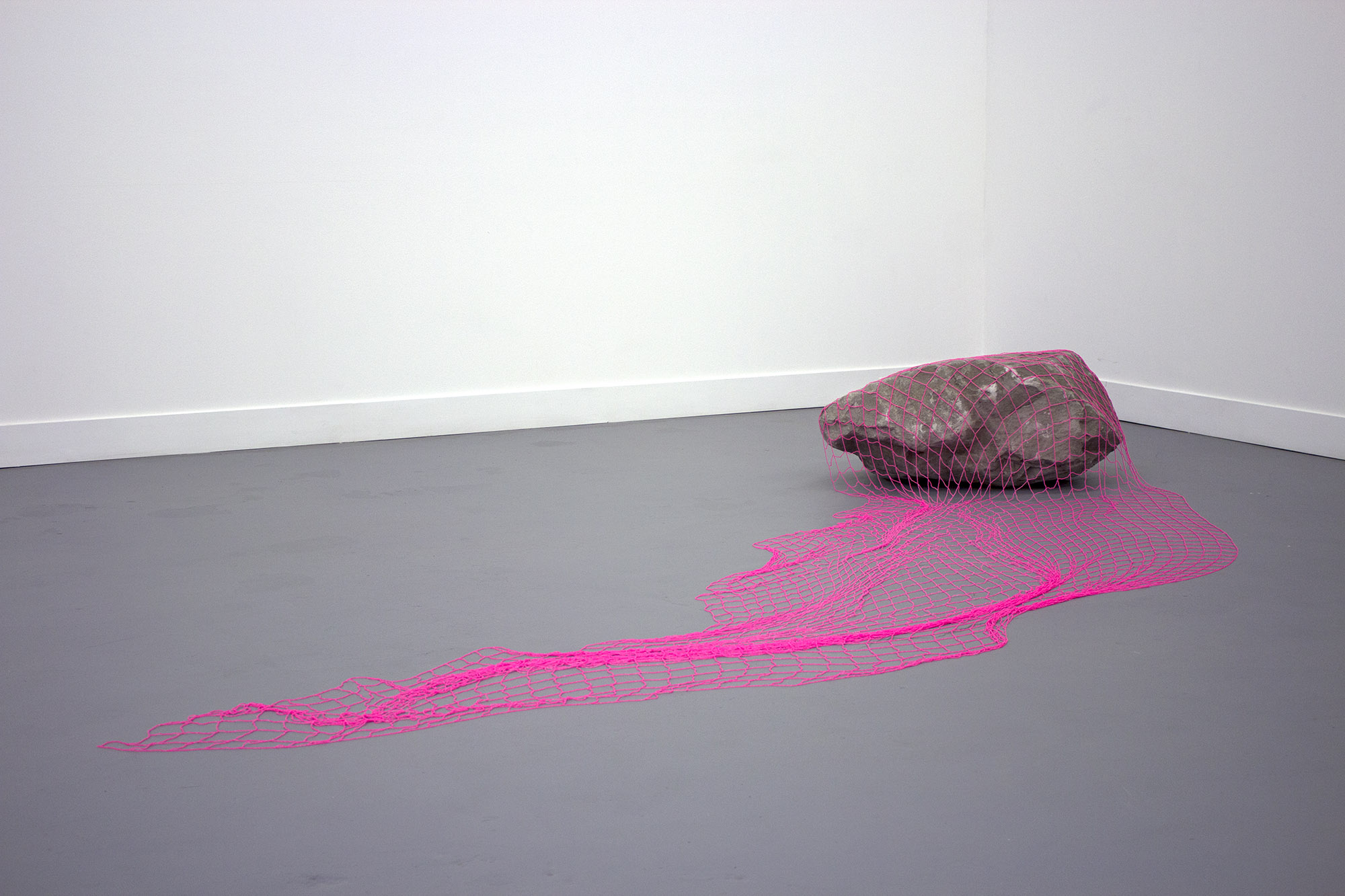 a veil to cover all stones , 2016 hand-beaded net, sandstone boulder 16.5 x 55.5 x 140 in. as installed TRUCK Contemporary Art , Calgary AB