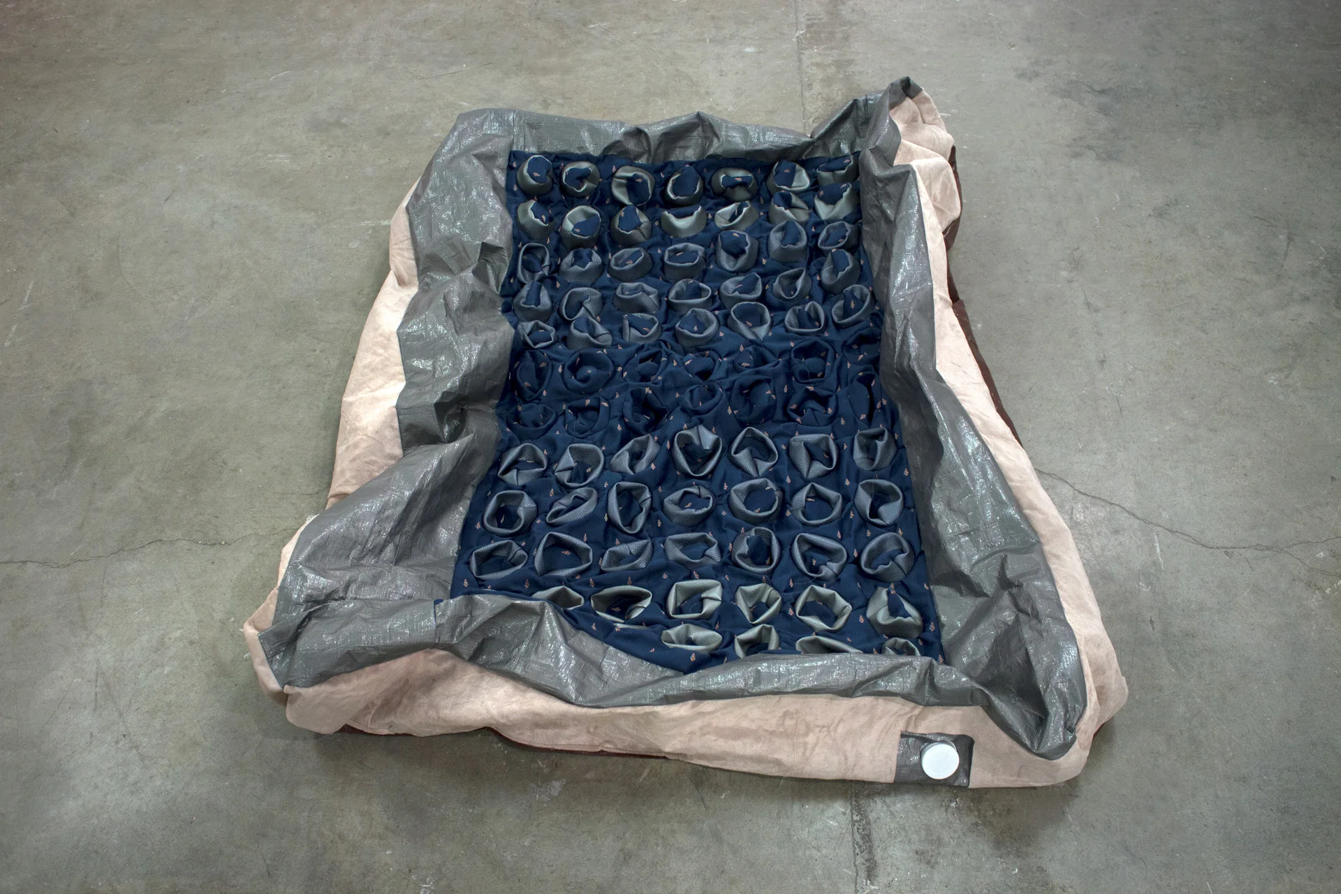 Sarah Schleer Fabric Design I, 2015 Virginia Commonwealth University Inflatables / Create an inflatable object that draws from one of the particular histories of inflatables including: sex objects, children’s toys, wartime vehicles, architecture, fashion, etc. Sarah created an inflatable mattress, substituting the scale of cupcake tins for the large dimples of a portable mattress. Her work often collapses the competing spheres of domesticity and homelessness.