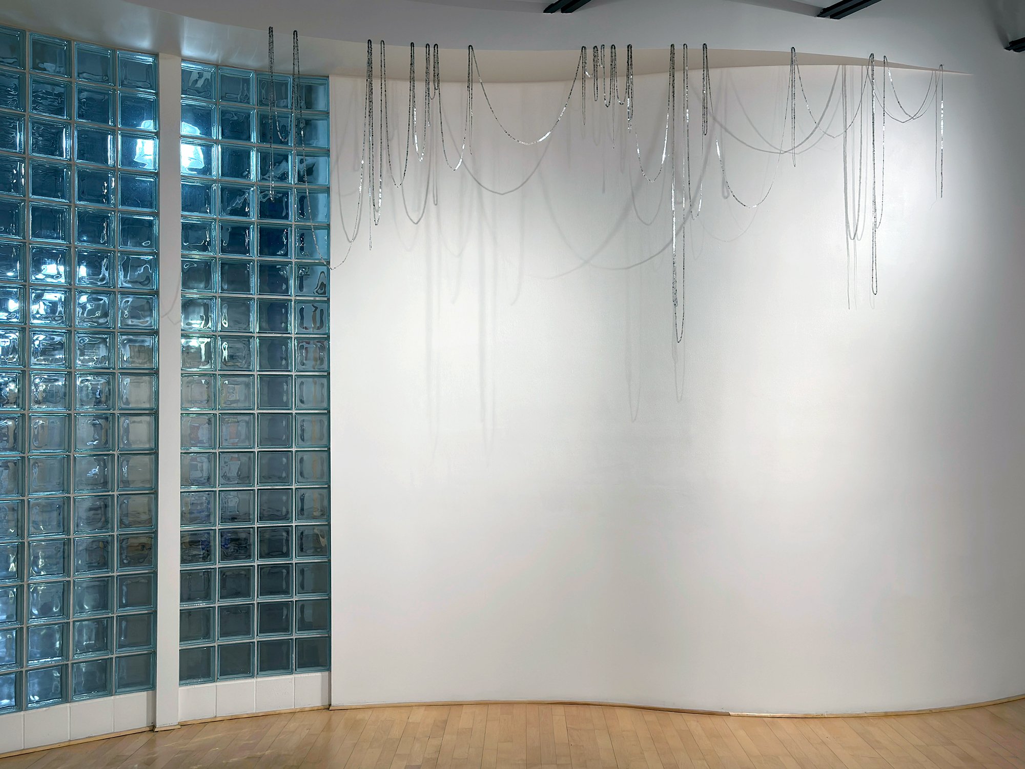    cloud seeds  , 2023 laser cut mica sequins, silver-wrapped silk thread, hand-stitched 150 linear ft. strand; 5 x 11 x 1 ft. as installed  Kristen Wigley-Fleming Gallery, Luther College, Decorah IA 