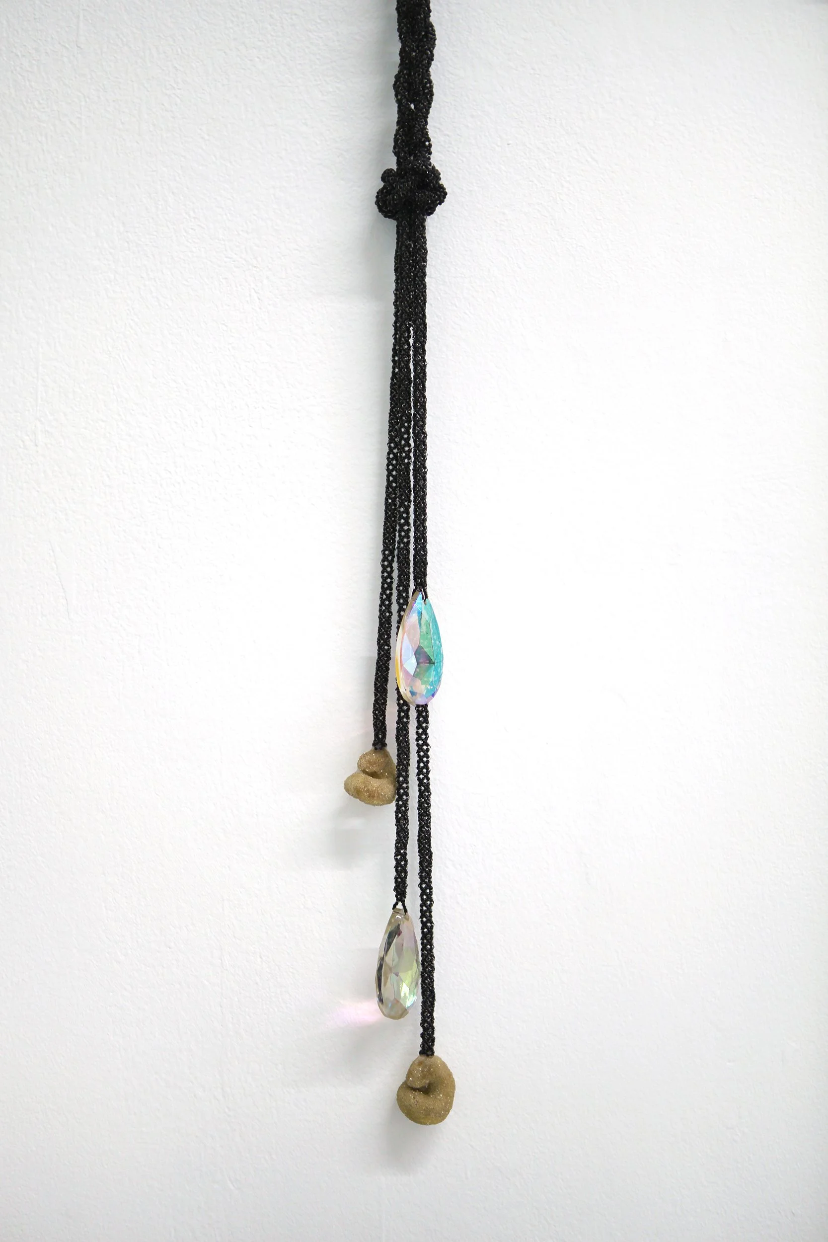    fossils  , 2025 (detail) hand-beaded and braided rope with glass beads, vintage a.b. chandelier crystals, and found marine fossils coated in glass road beads 25 × 19 in. 