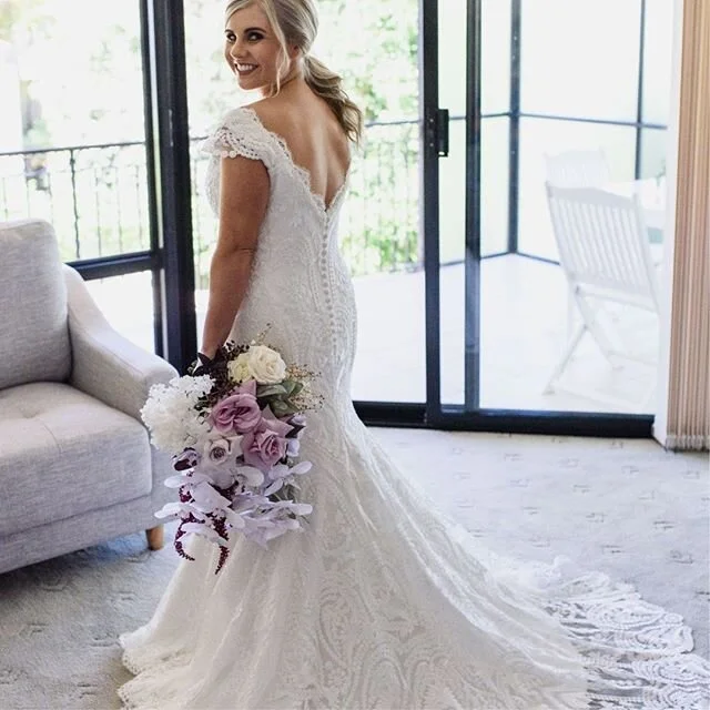 Look at that beautiful smile.✨💖 Precious Carla tied the knot last month in her made to measure @paulaandjo gown. The low v-shaped back creates extra drama as the lace overlay drapes behind her. Congrats to the bride and the entire team involved on the big day!⠀
Photographer: @melissasphotographyperth ⠀
Florist: @floralarmy⠀
MUA: @makeup_by_hayley_rule