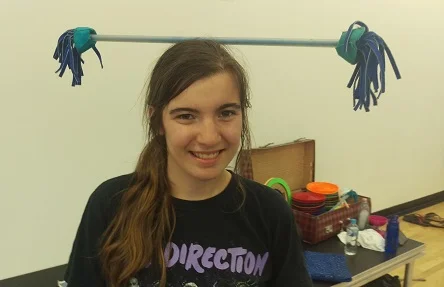 Emily balancing flower stick on head.jpg