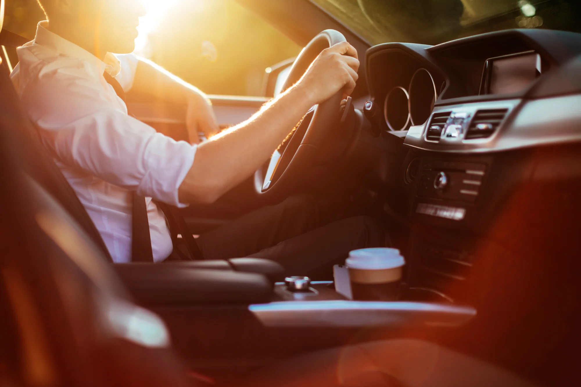 Businessman-driving-a-car-623117826_8574x5715.jpg