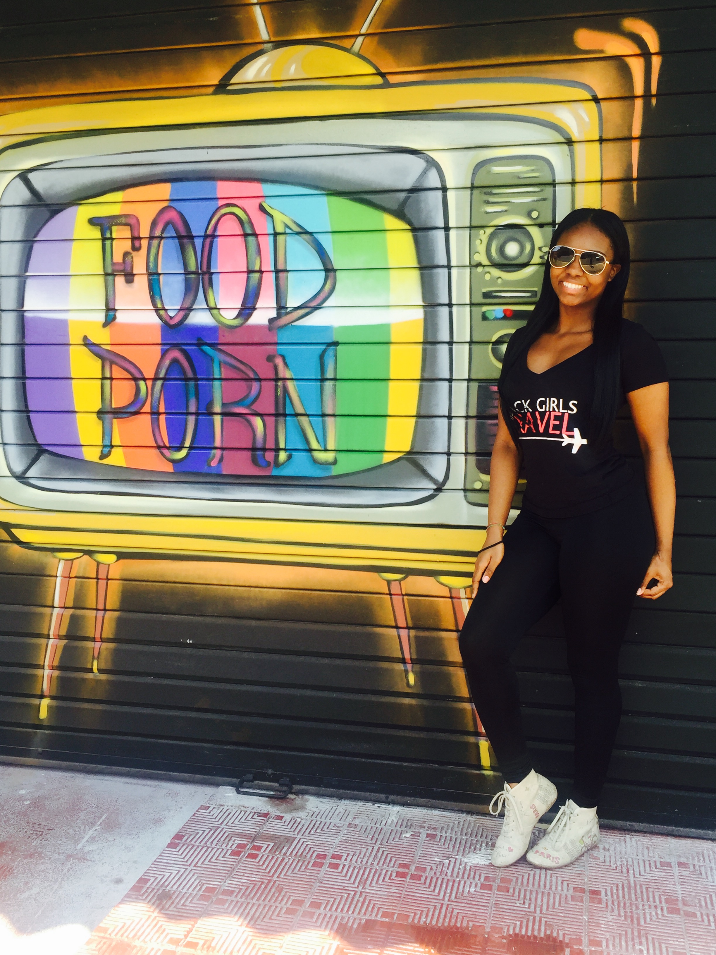 Heredia, Costa Rica | 2016 | 21 years old We ate at the same cafe everyday after classes and we'd walk pass this graffiti art. I love food and art. If you want a "Black Girls Travel" T-Shirt check out Girls Going Global . I'm wearing my favorite travel sneakers that I bought in Turkey. They're decorated with a Paris theme. 