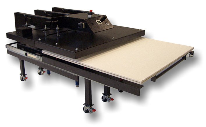 Large flatbed machine with black control panel, mounted on a wheeled black metal frame, with a beige material or surface on one side