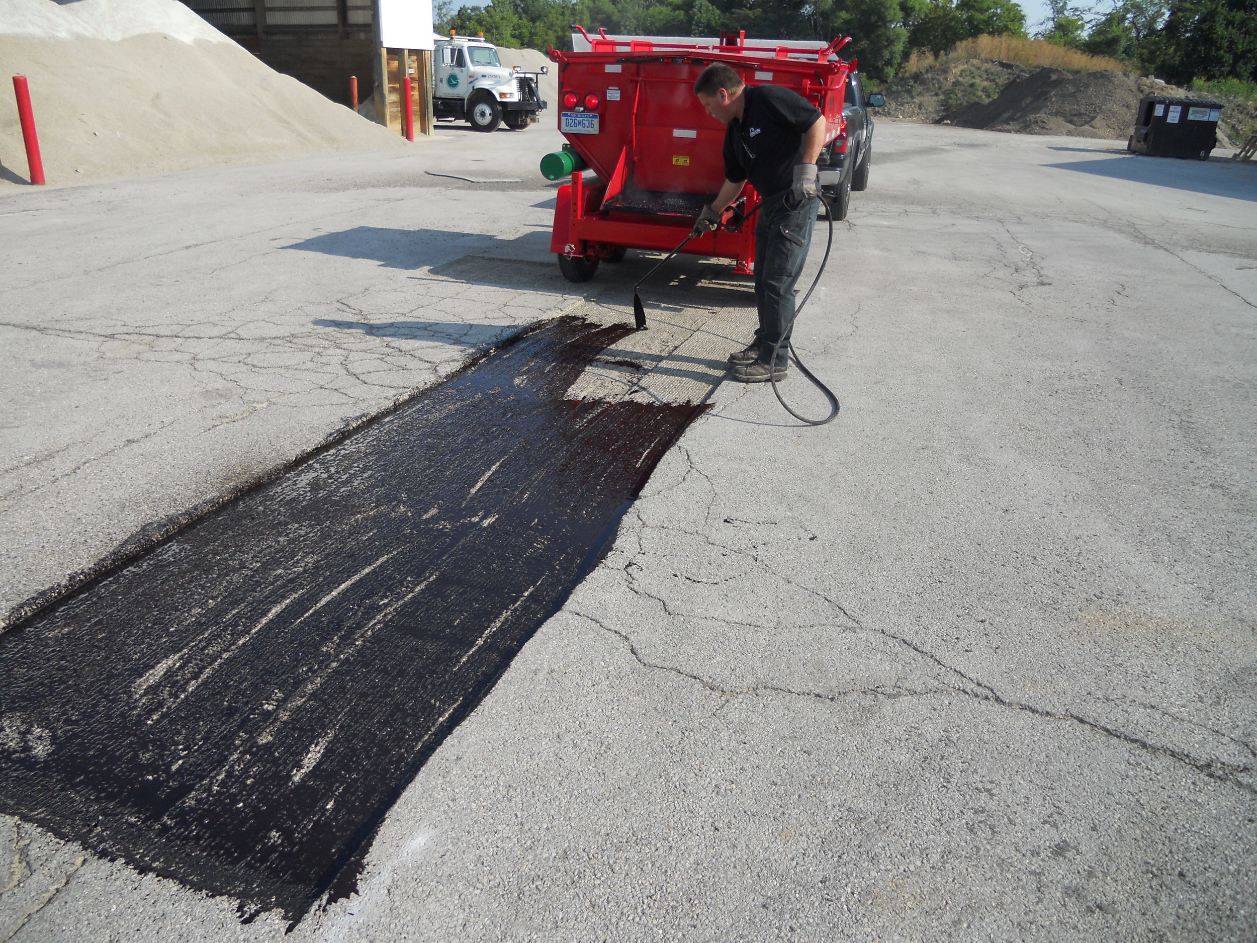Spraying Utility Cut Patch with Asphalt Tack Material