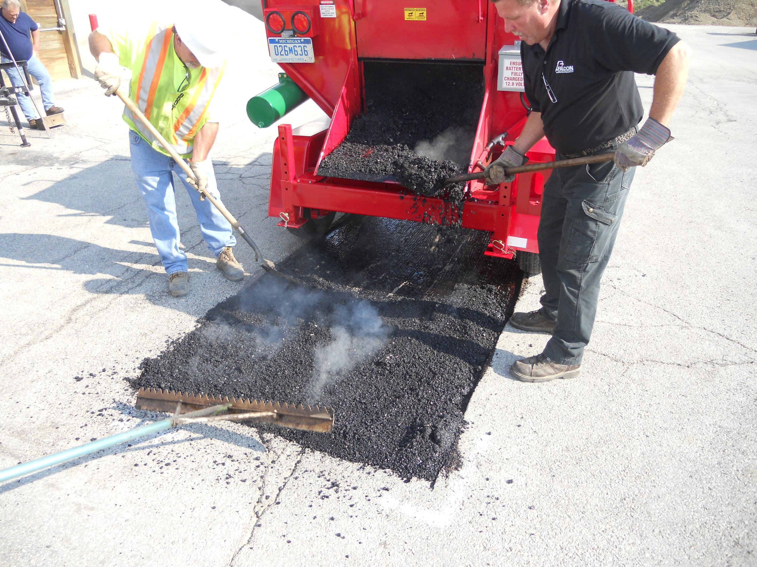 Offloading recycled asphalt into a Road Patch