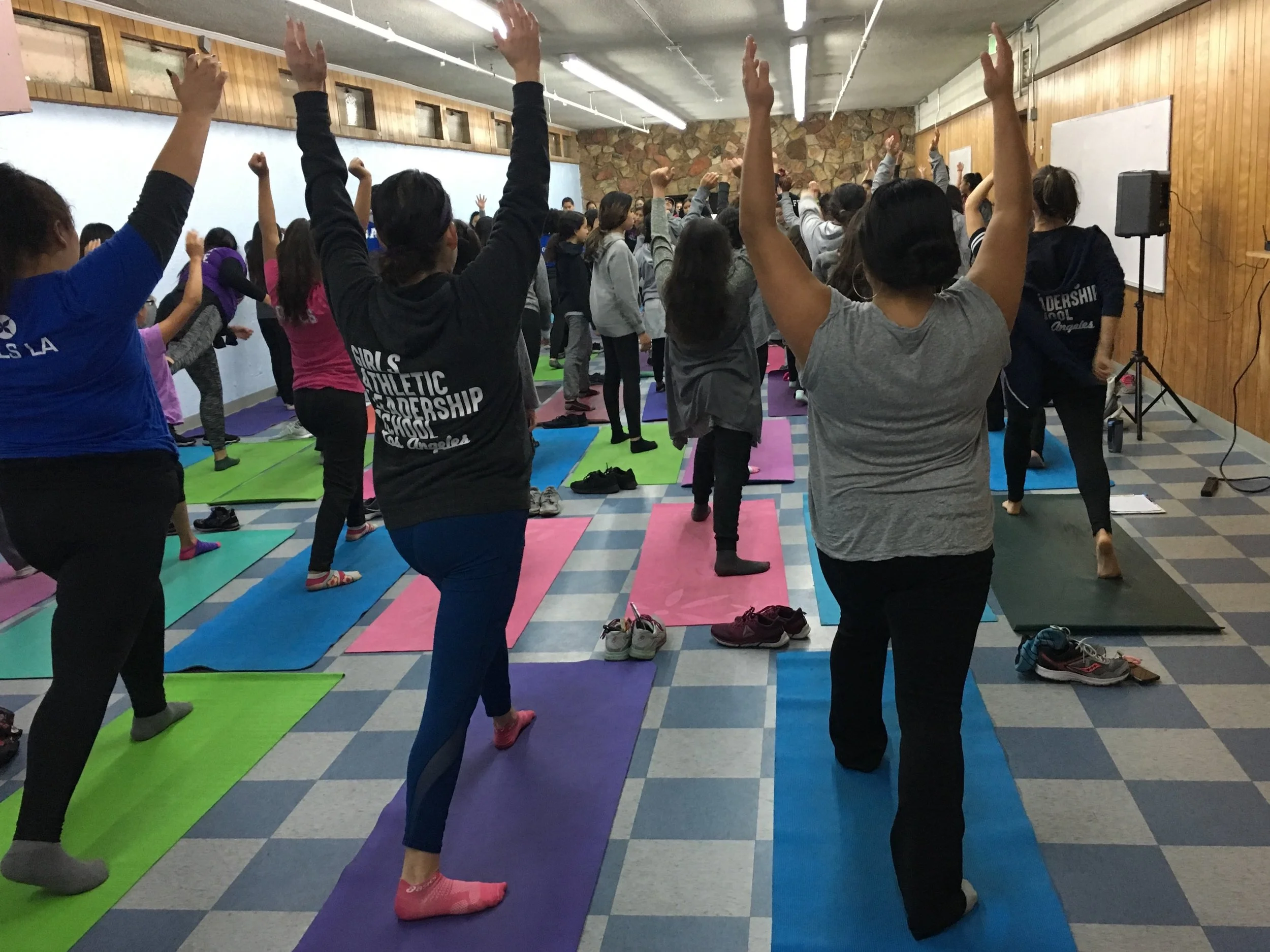 Jazmin and Vanessa Garza, founding principal of Girls Athletic Leadership School, doing yoga with her middle school students and staff.