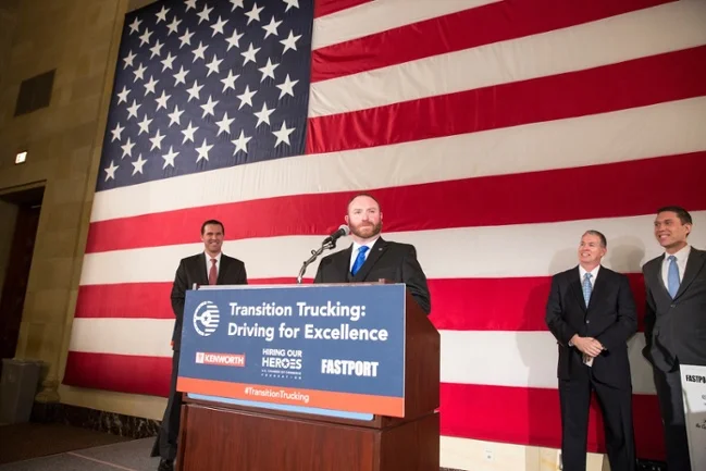 Transition Trucking: Driving for Excellence Award Winner Troy Davidson addresses audience at the U.S. Chamber of Commerce's Hall of Flags. (Left to Right) Hiring Our Heroes President Eric Eversole, FASTPORT President Brad Bentley, and Kenworth Marketing Director Kurt Swihart look on. 