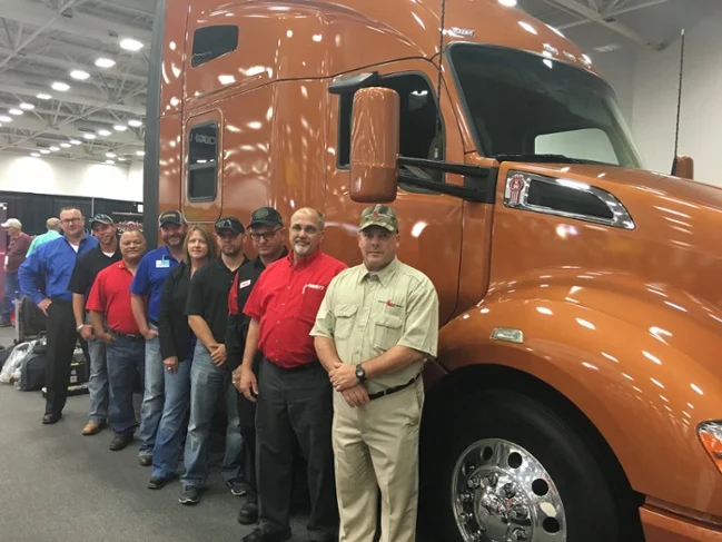 Top 10 Finalists for the Transition Trucking Award in front of a fully-loaded Kenworth T680, the same model they were nominated to win. From left to right: Brandon Douglas, Kevin Scott, Eli Tollinchi, Troy Davidson, Robyn Hyde, Jonathan Perez, Russell Hardy, Steven Cassaday, and Edward Cavanagh (not pictured: Christopher Scott).