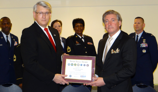Alex Baird, ESGR Executive Director (left) presents Bill McLennan, FASTPORT CEO (right) with Seven Seals Award. (Photo courtesy of ESGR Headquarters.)