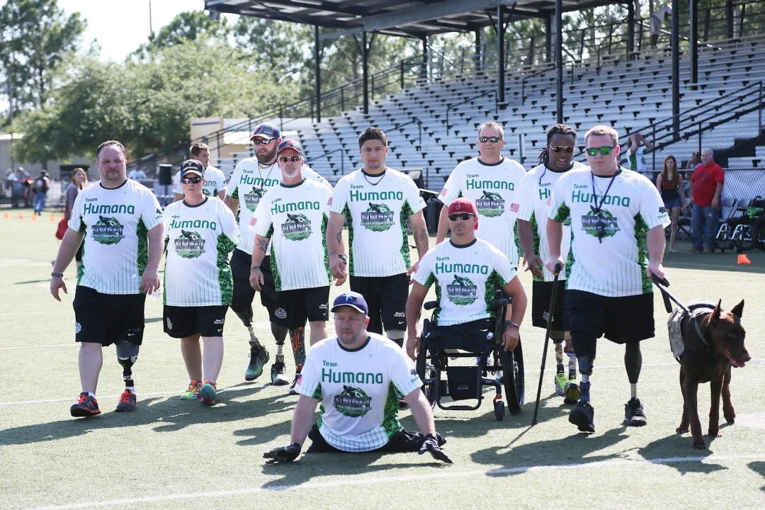 Members of the Wounded Warrior Amputee Football Team surveying the field before the charity football game begins where they defended their undefeated record. 