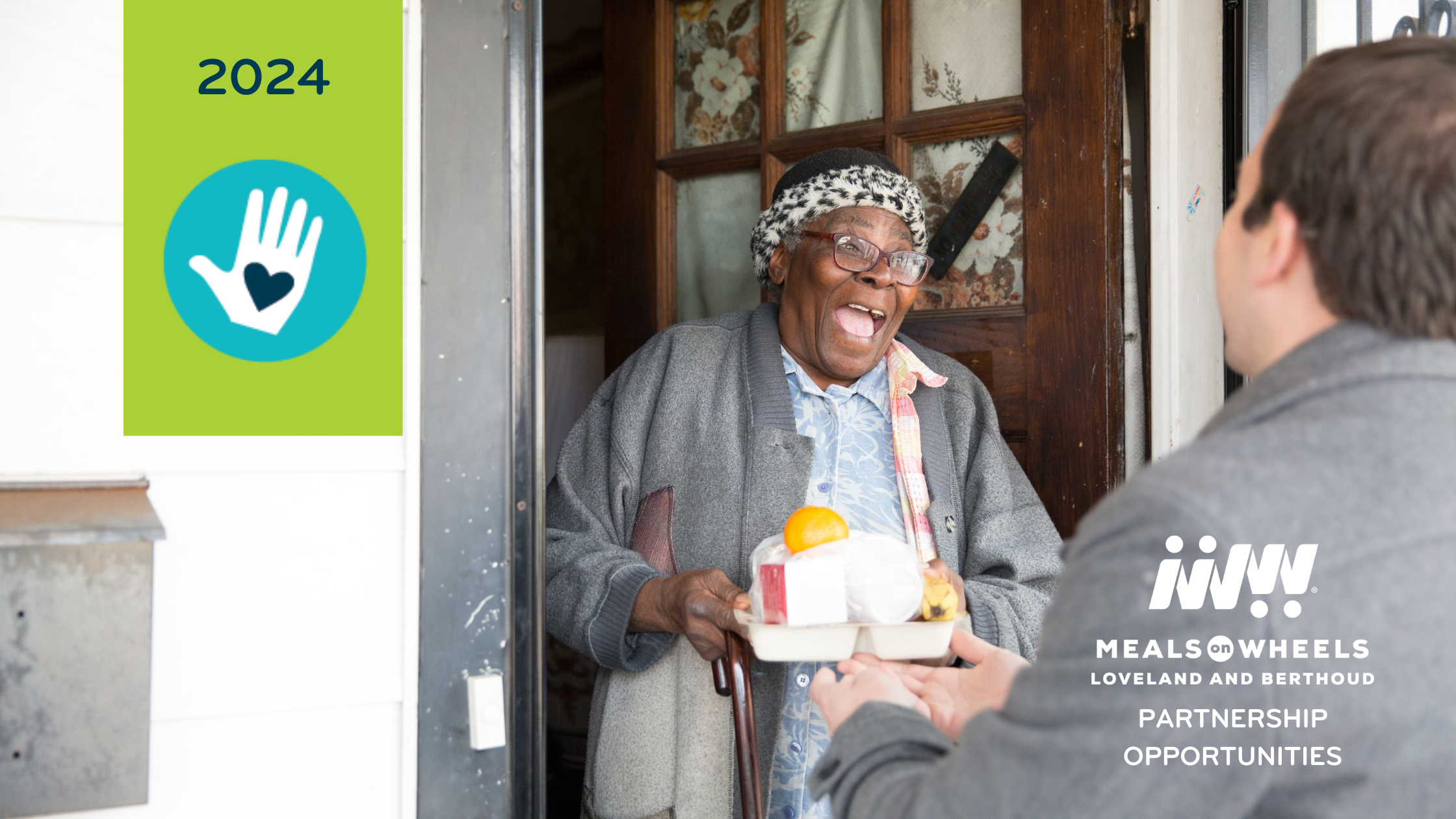 A woman smiling as she takes a tray of food