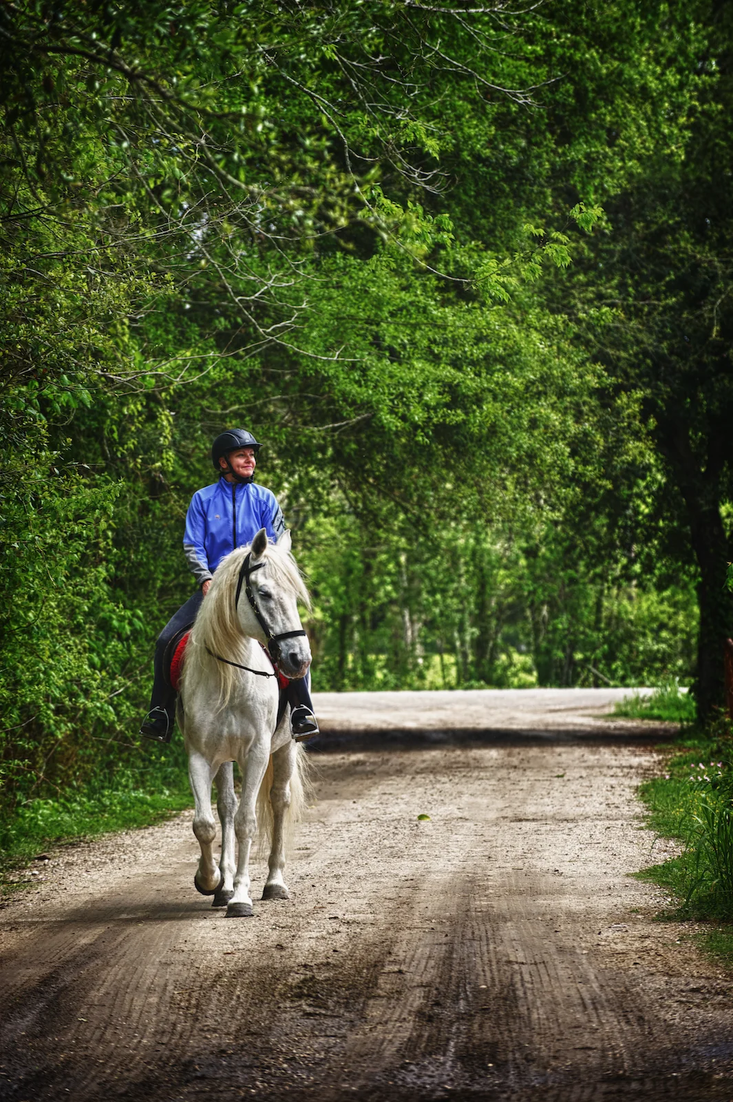 A woman poses with her horse on the Westbank of New Orleans. Photographed by New Orleans based photographer, Marc Pagani