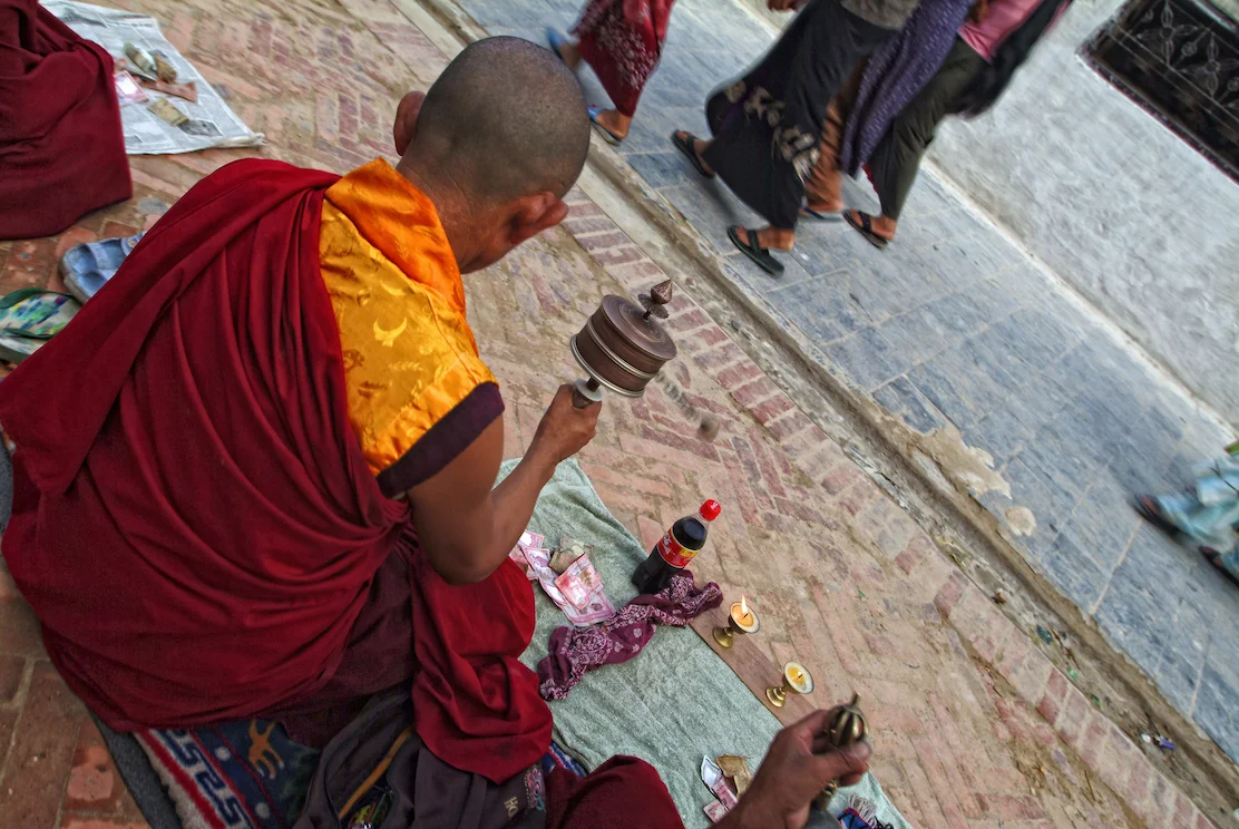Buddhist monks pray near the Boudhanath Temple Stupa in Kathmandu, Nepal. Image by New Orleans based travel photographer, Marc Pagani - marcpagani.com