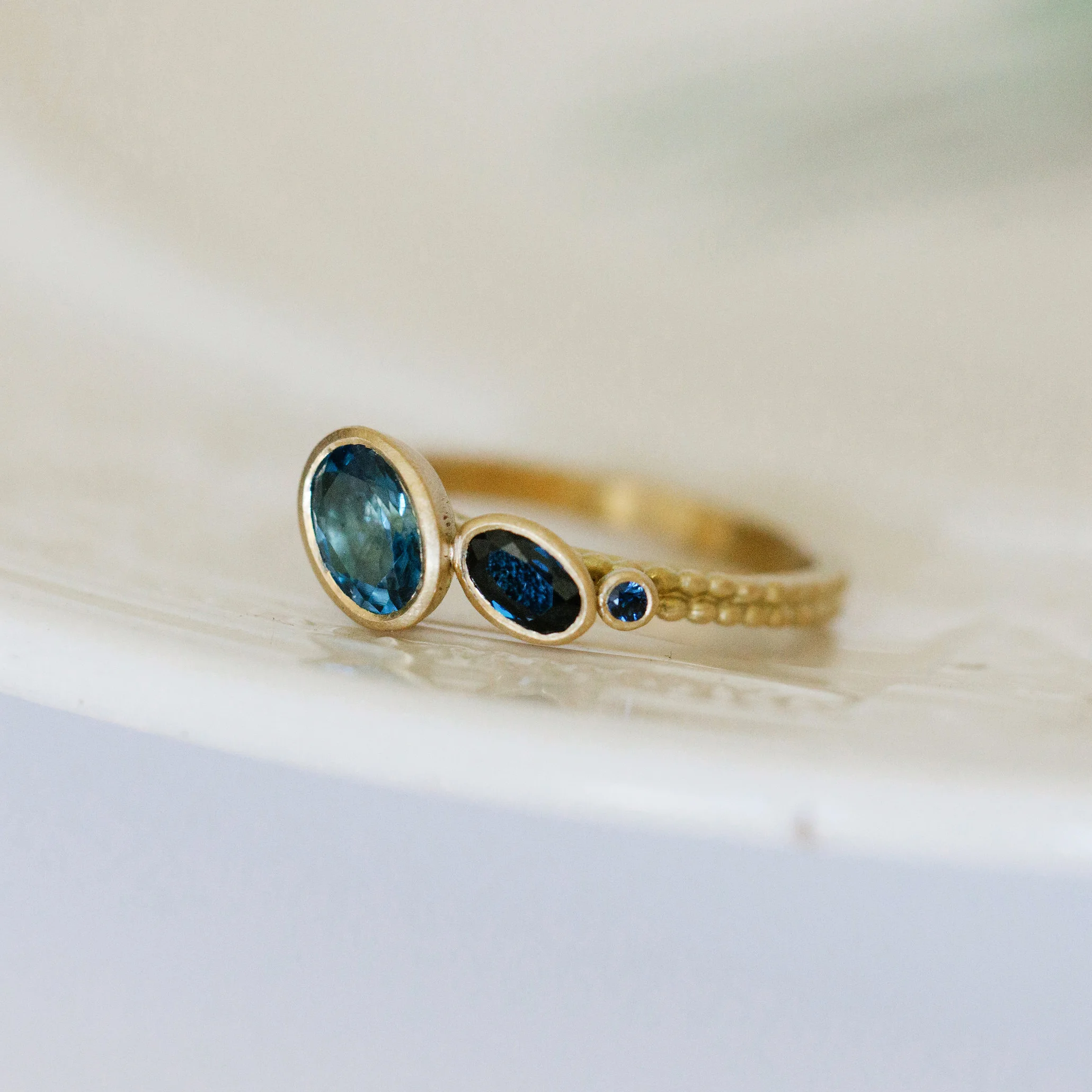 Off-Set Aquamarine and sapphire Coupled Dotty Ring