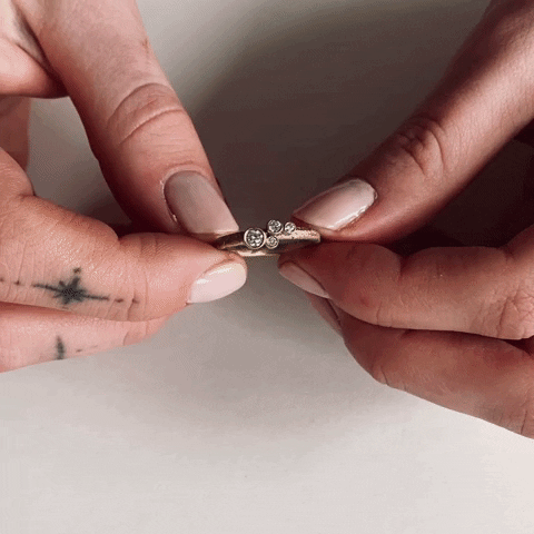 trying on the organic brushed gold and diamond engagement ring