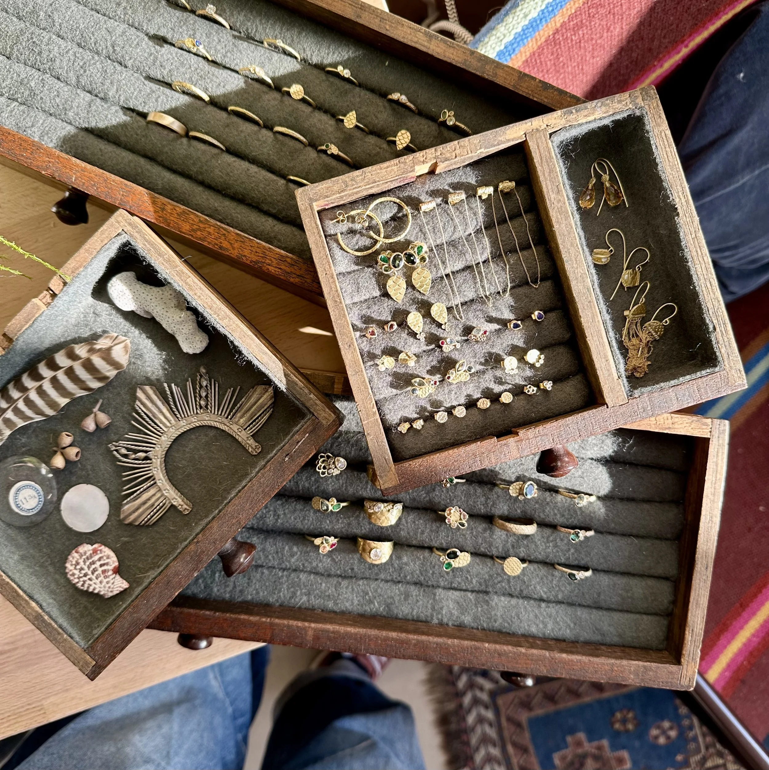 A selection of AM Jewellery displayed in jewellery boxes