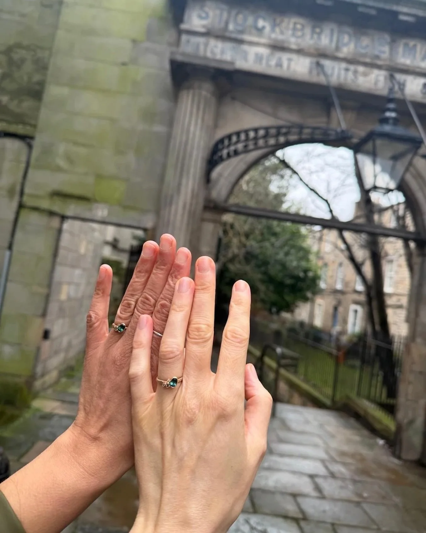 couple wearing matching bespoke wedding rings made in scotland