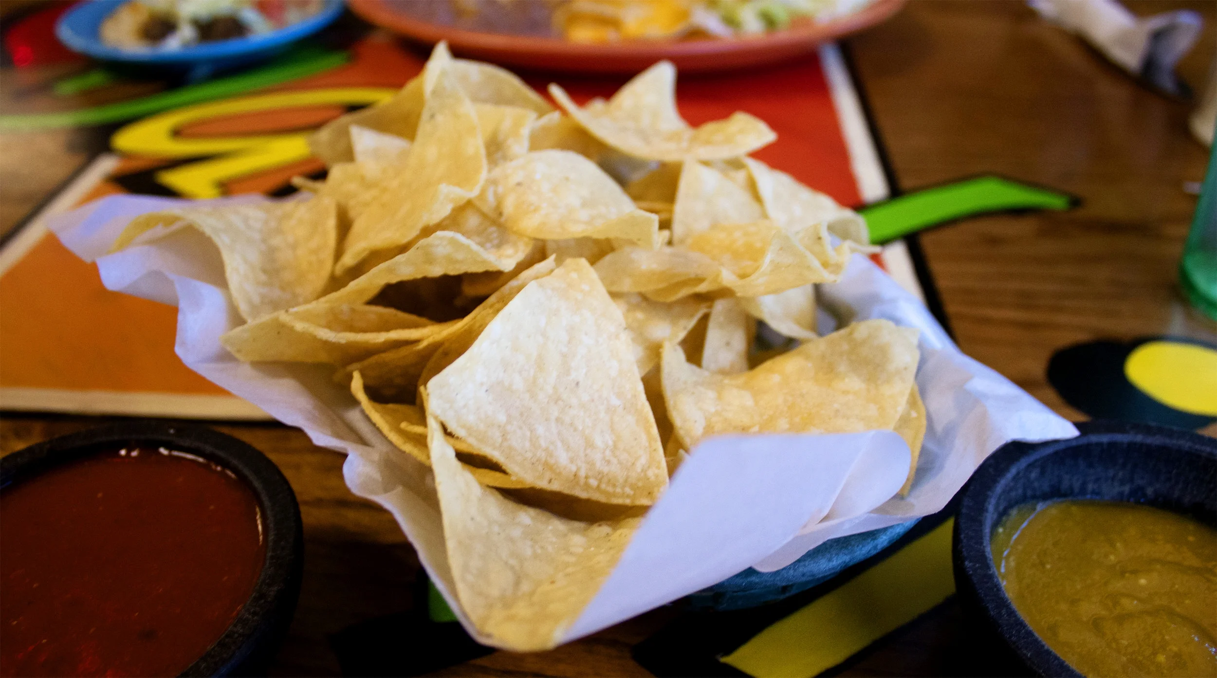 FREE COMPLEMENTARY FIRST BASKET OF OUR HOUSE TOSTADA CHIPS WITH RED AND GREEN SALSA