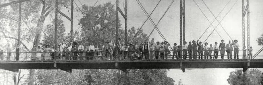 Spectators, 35 men and six women, are lining up for a photograph, or to look at the bodies, along with 17 children, toddlers to mid-teens. Okemah, Oklahoma, May 1911. Photo by George Henry Farnum