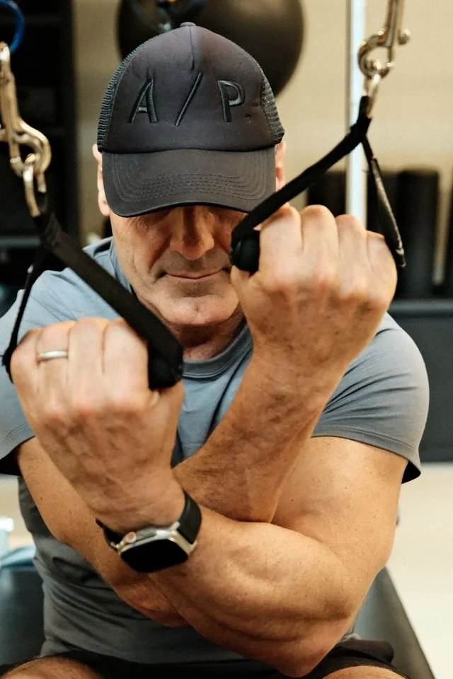 Man using cable resistance equipment at Athletica Pilates studio, Forest Lodge Sydney