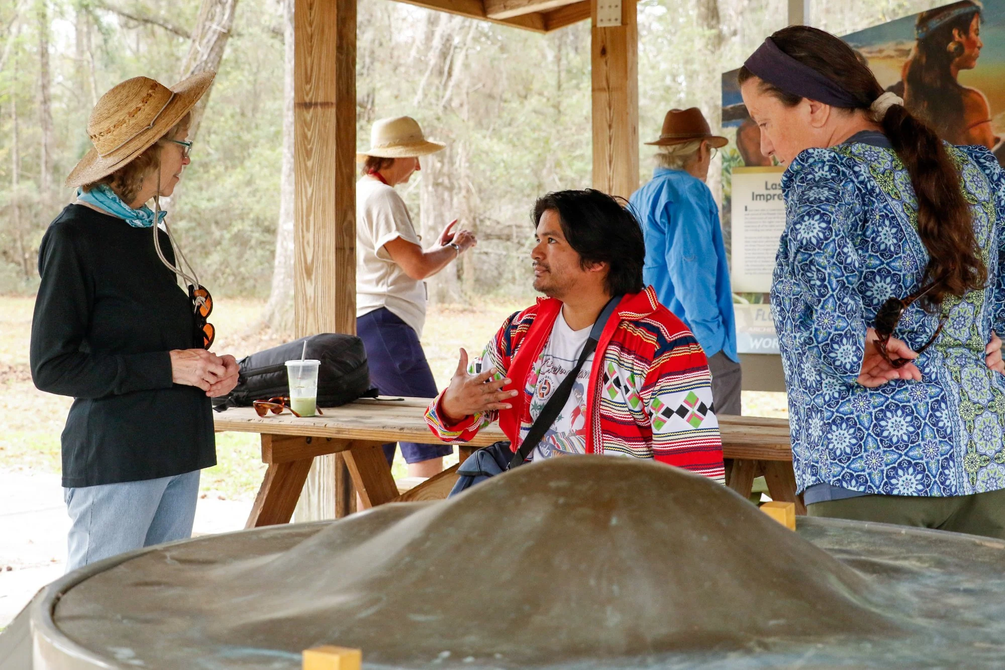 Members of the Miccosukee Tribe speaking to an audience.