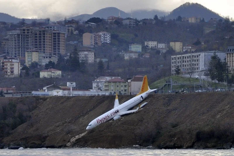 Plane dangles off cliff after skidding off runway in Turkey