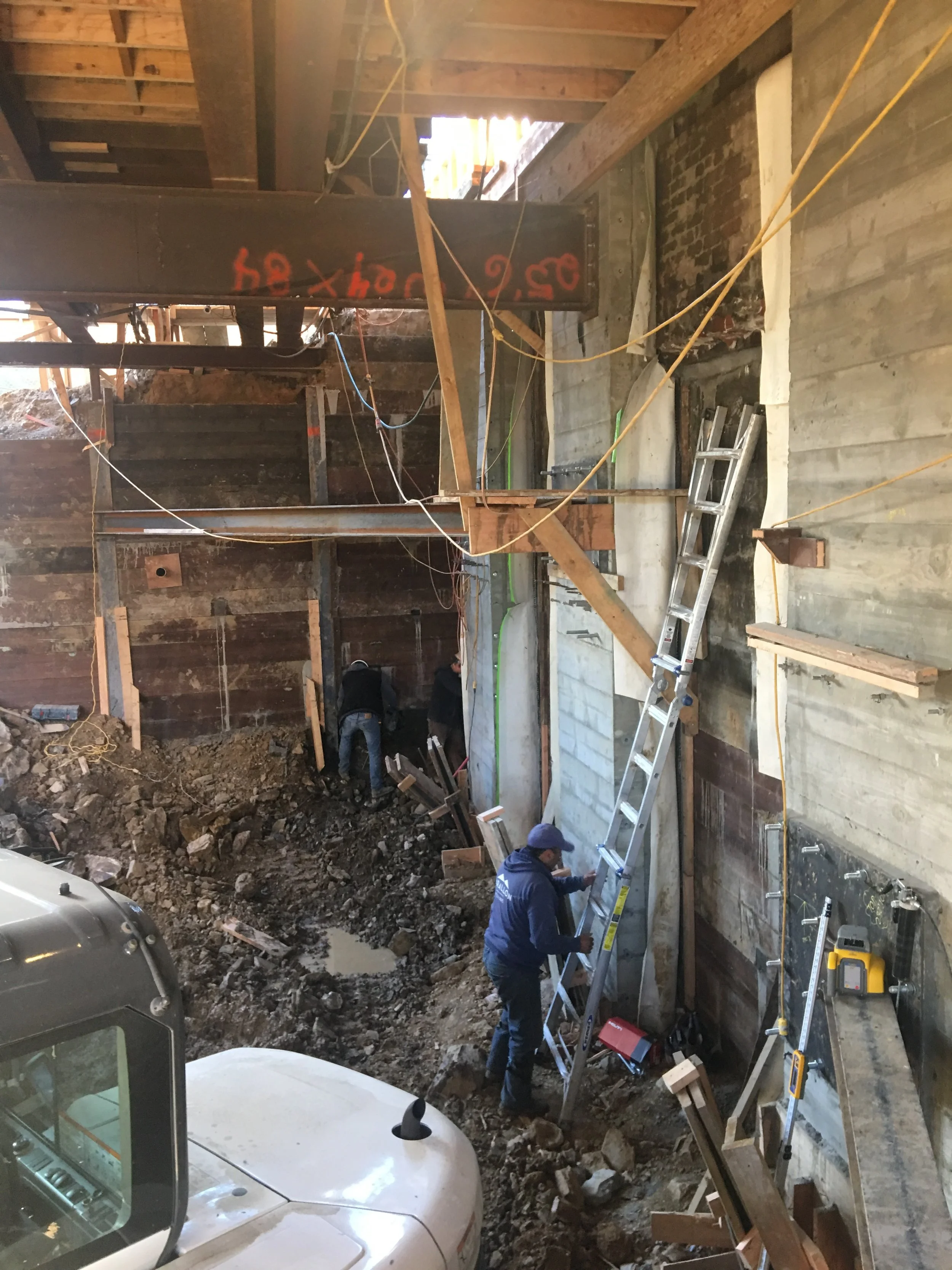  Excavating under a house to create two additional basement levels. 