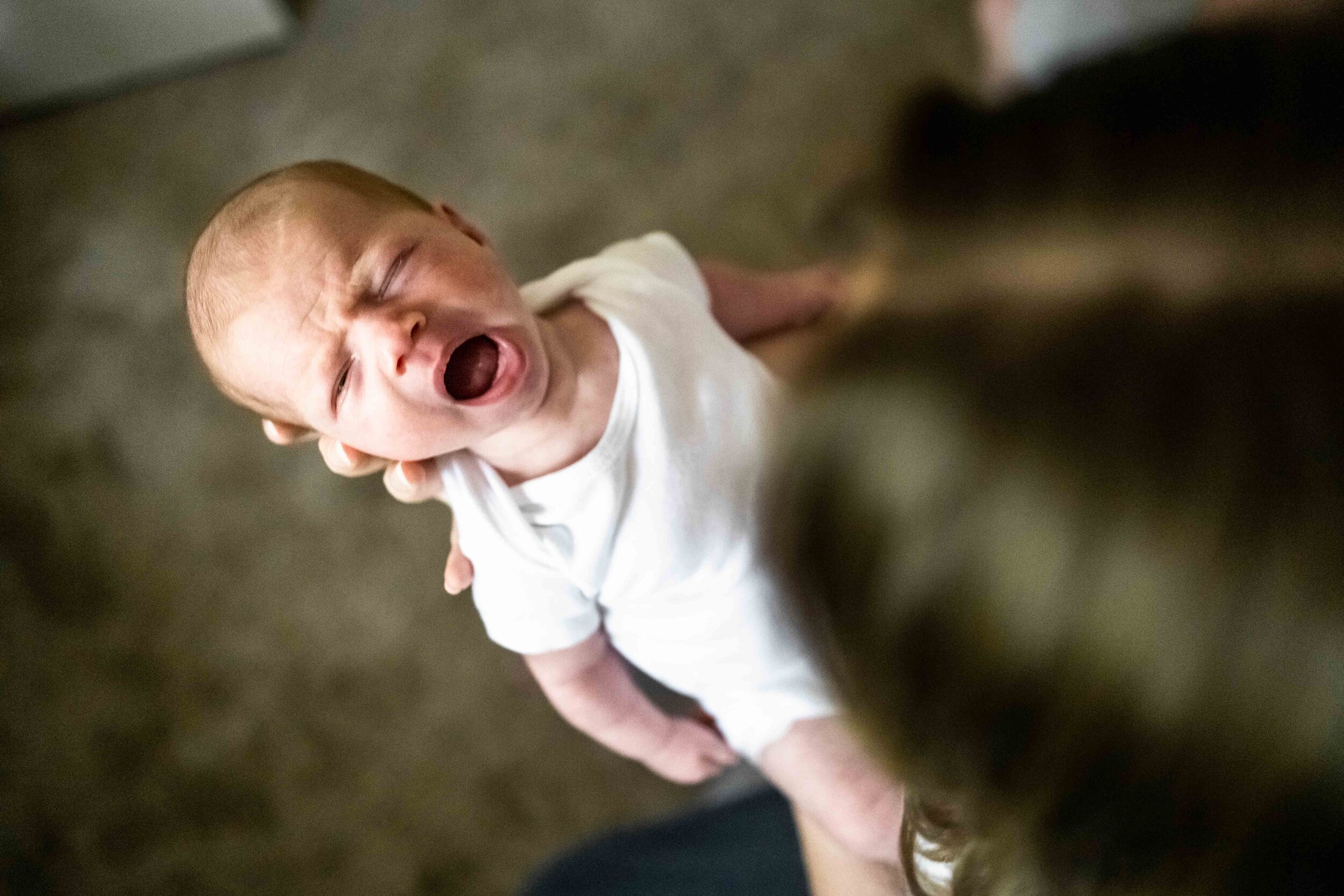 Newborn baby yawns big at in home newborn session in Bellevue.