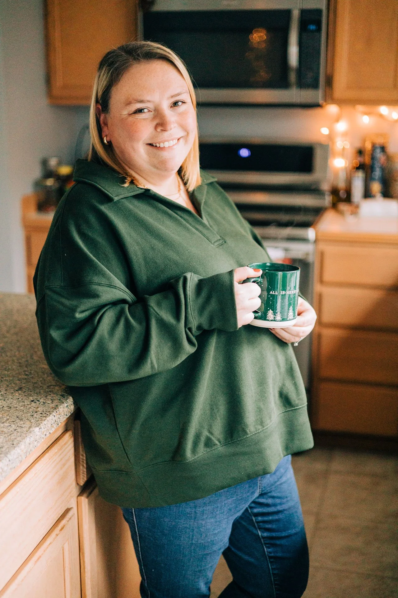Sam Dorn from Learning to Bloom poses with a cup of tea in her kitchen.