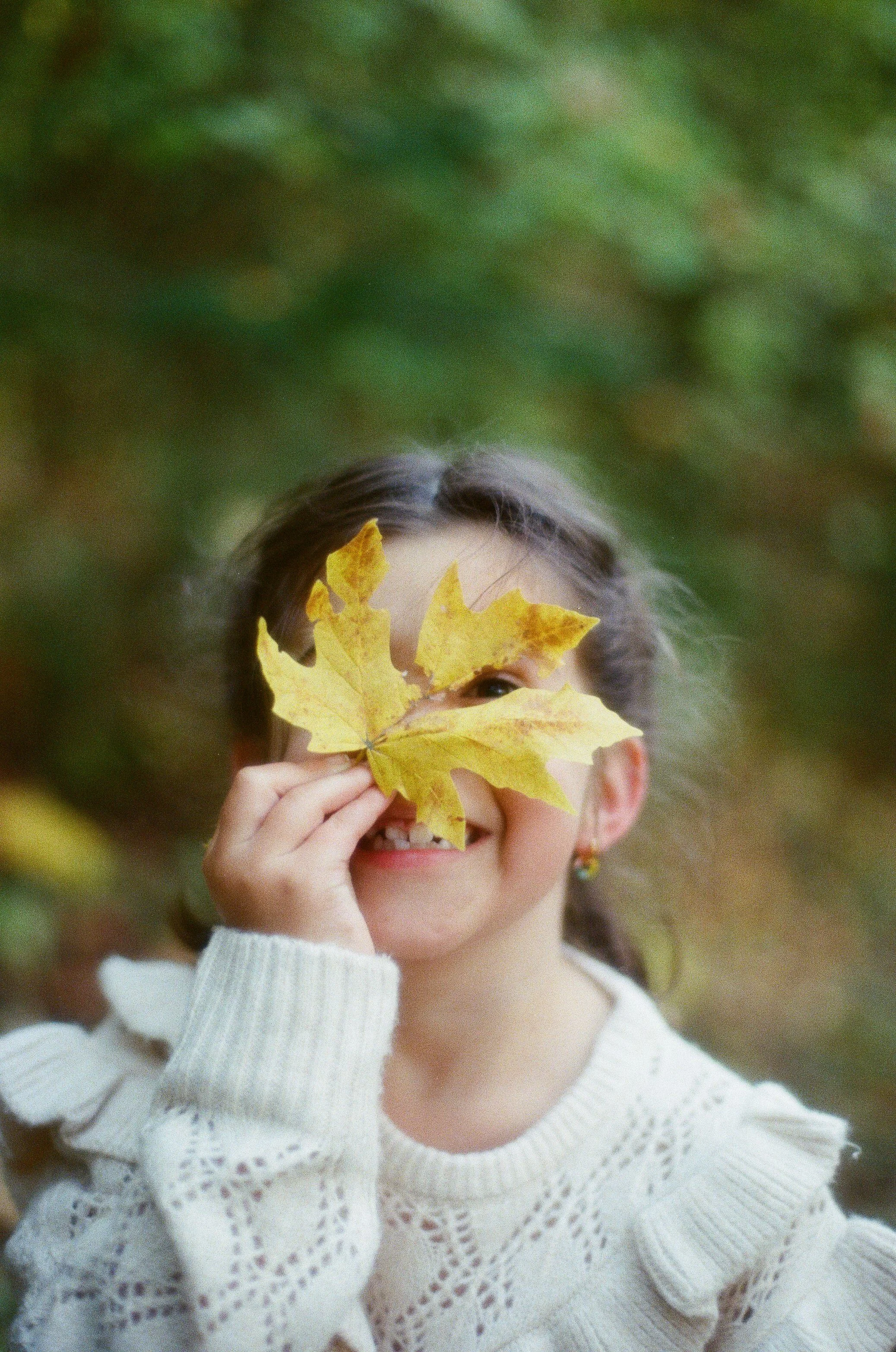Portrait of a Seattle girls with a fallen leaf over her eye.