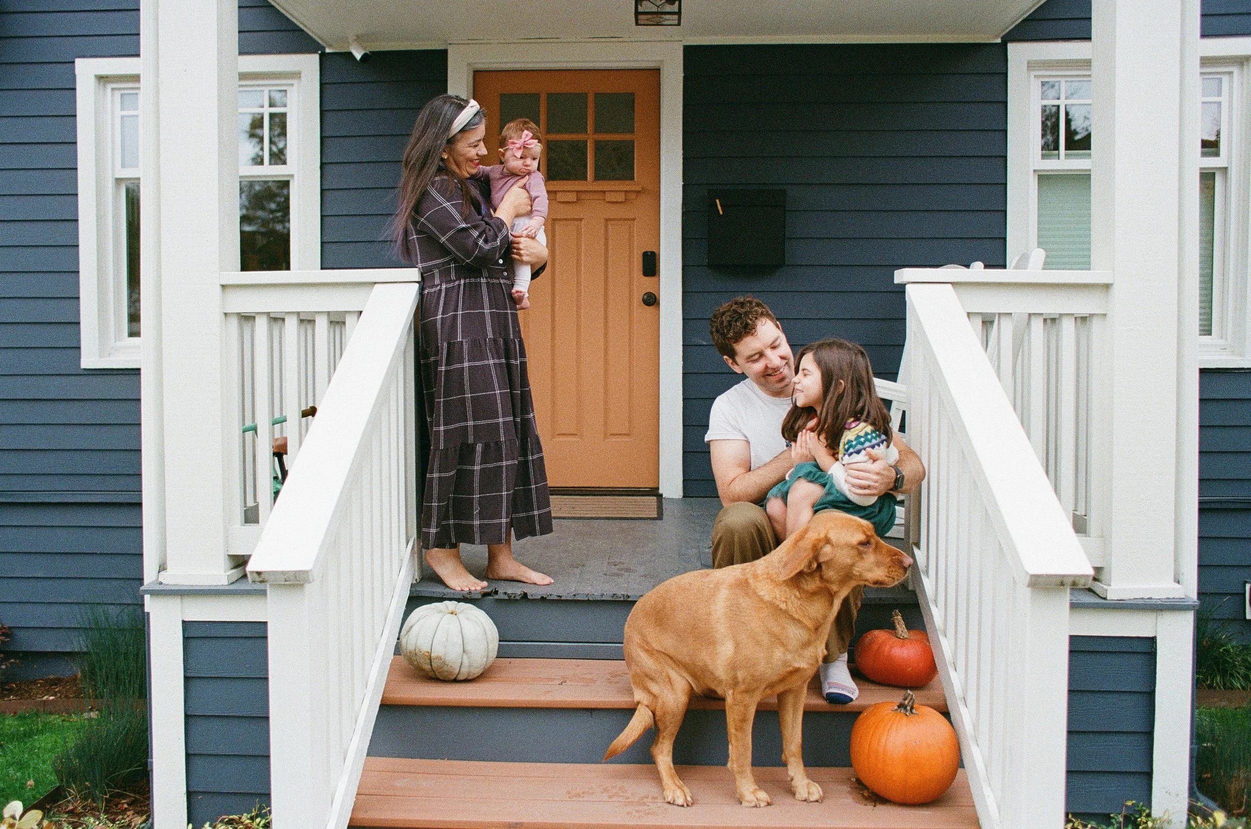 Madrona Seattle Family enjoy the front porch in fall with their dog.