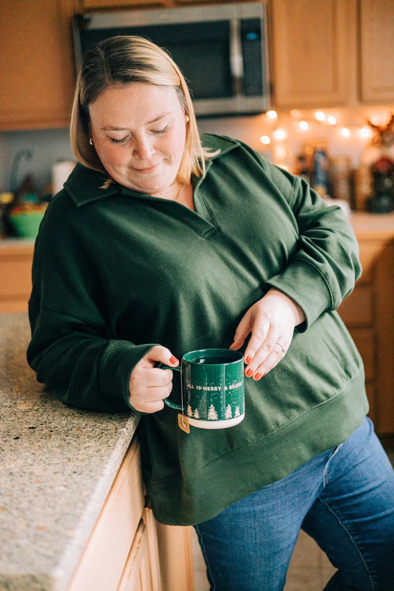 Sam Dorn from Learning to Bloom poses with a cup of tea in her kitchen.