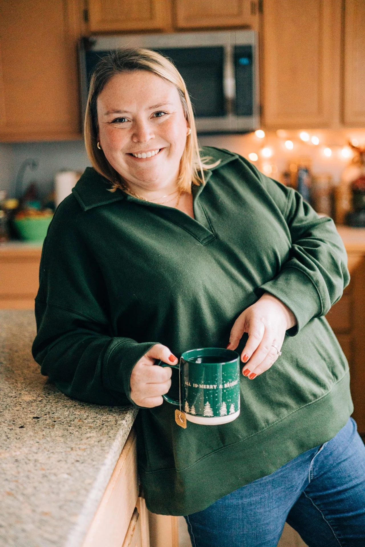 Sam Dorn from Learning to Bloom poses with a cup of tea in her kitchen.
