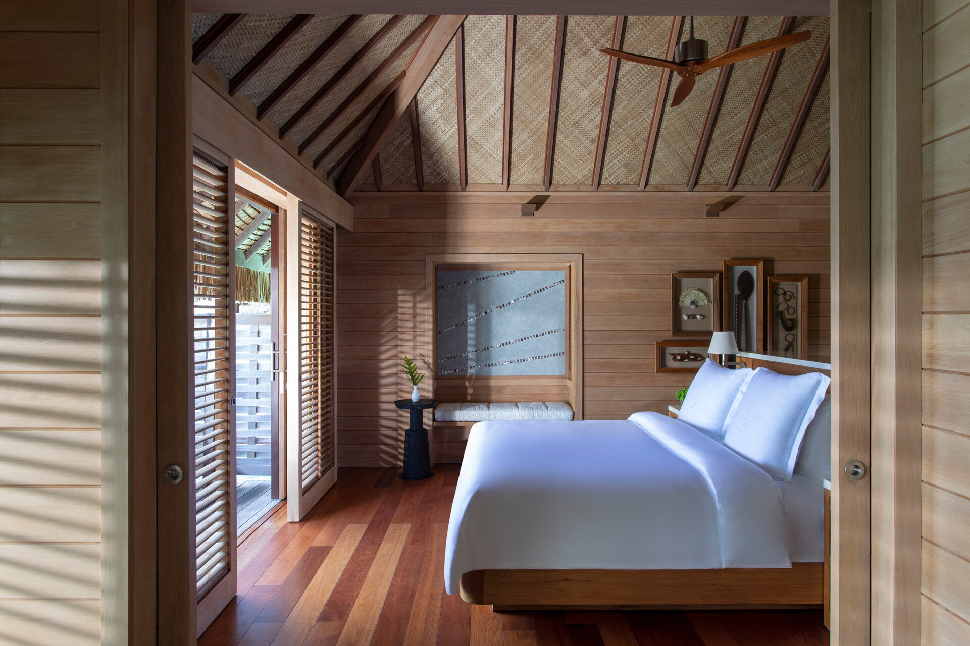   A bedroom in an over-water bungalow (photo credit: Four Seasons Hotels &amp; Resorts)  
