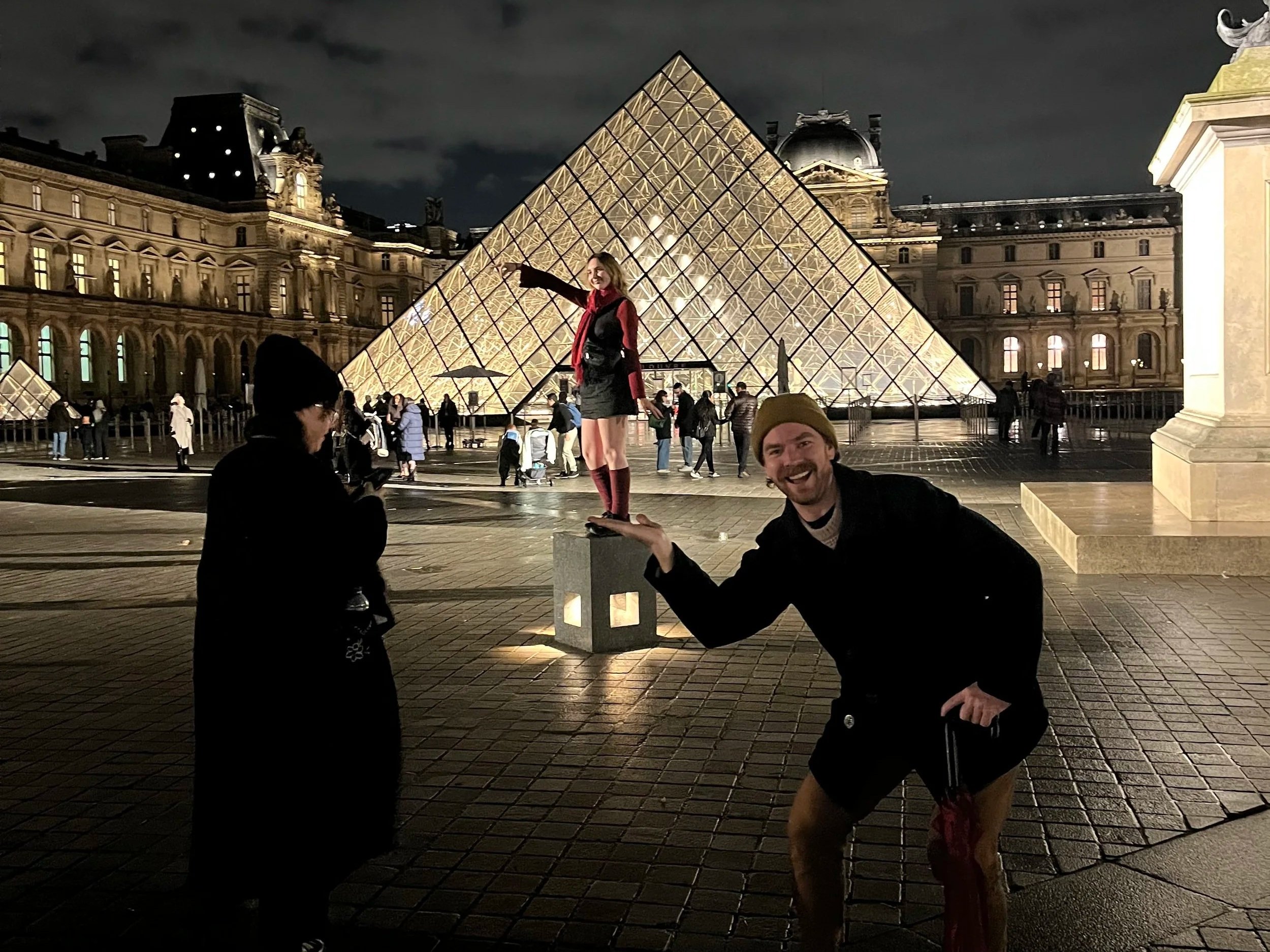Team from SCM Architects Group on a private group trip to Paris with Poe Travel and Decouvertes outside of the Louvre glass pyramid