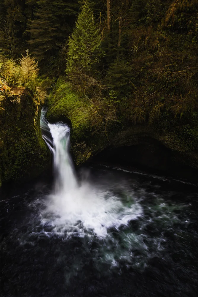 Punchbowl Falls, Eagle Creek Washington. Captured in autumn light the waterfall streams through the image.