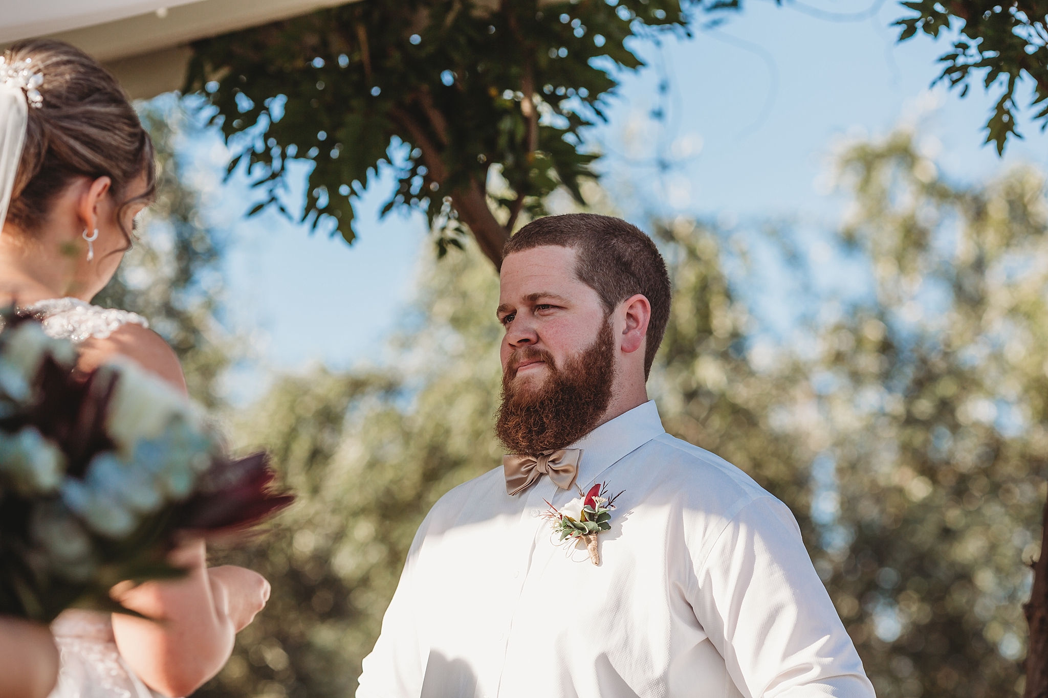 groom listening to bride say her vows