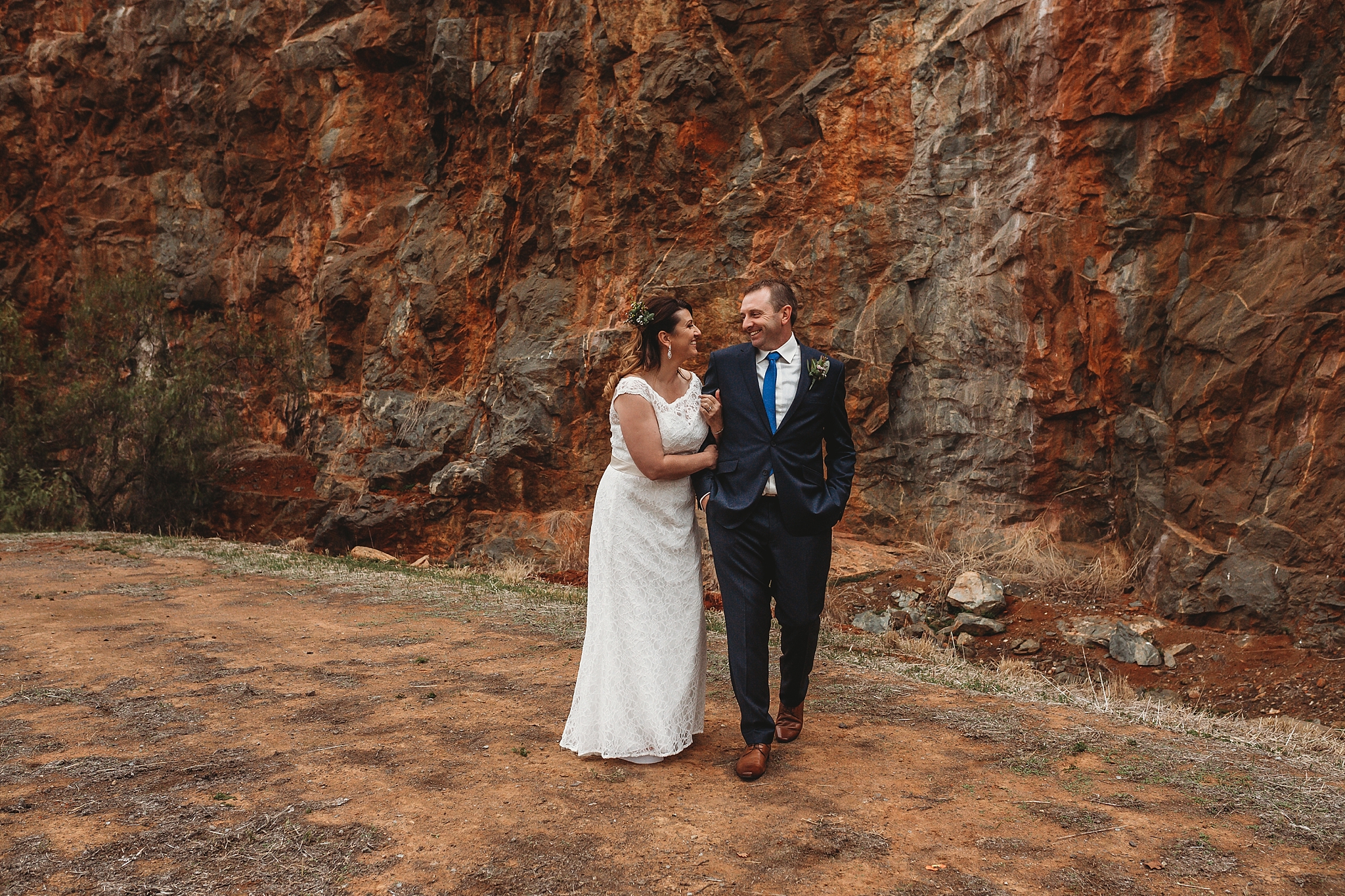bride and groom walking and laughing at dookie quarry